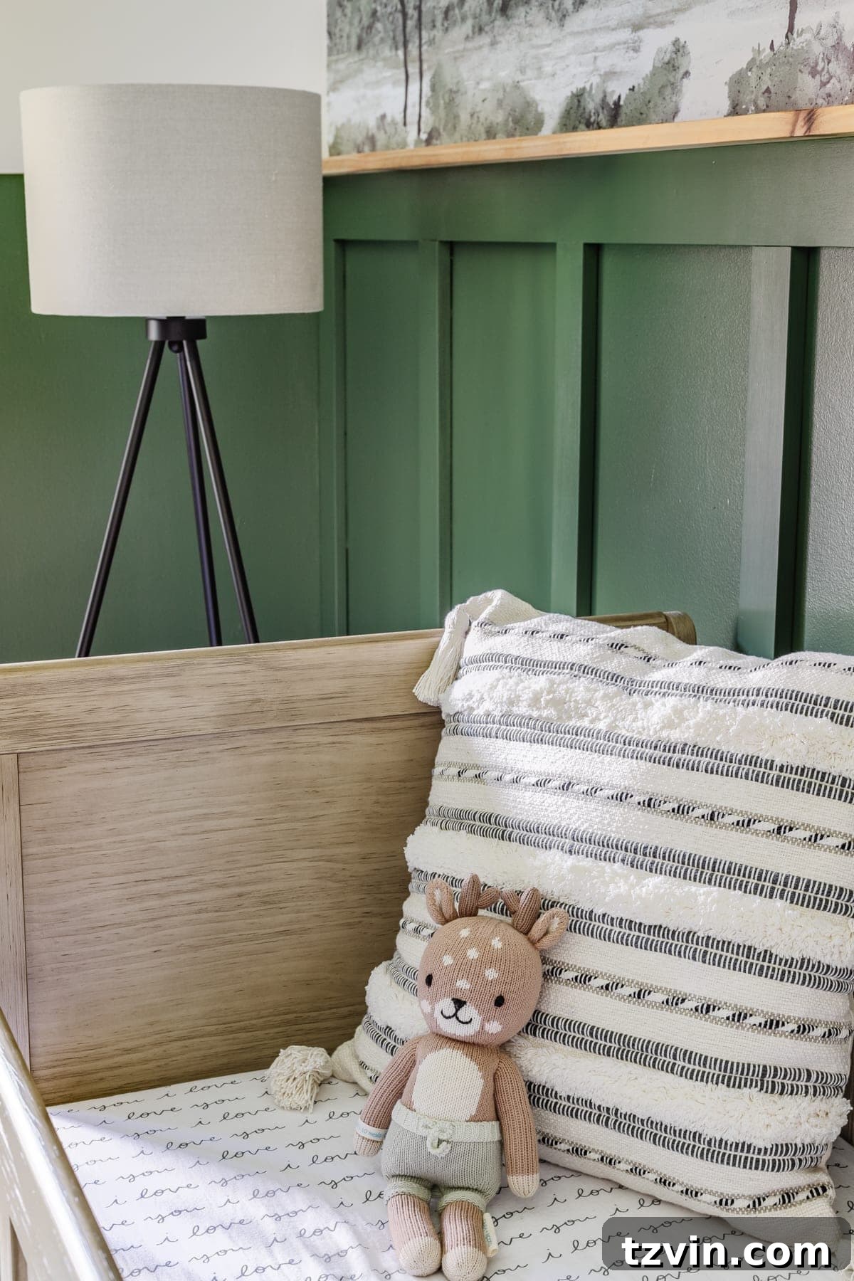 Our Cozy Woodland Wonderland: Baby Boy Nursery Transformation 16 Baby boy nursery with woodland theme, floor lamp, and striped pillow with natural wood crib