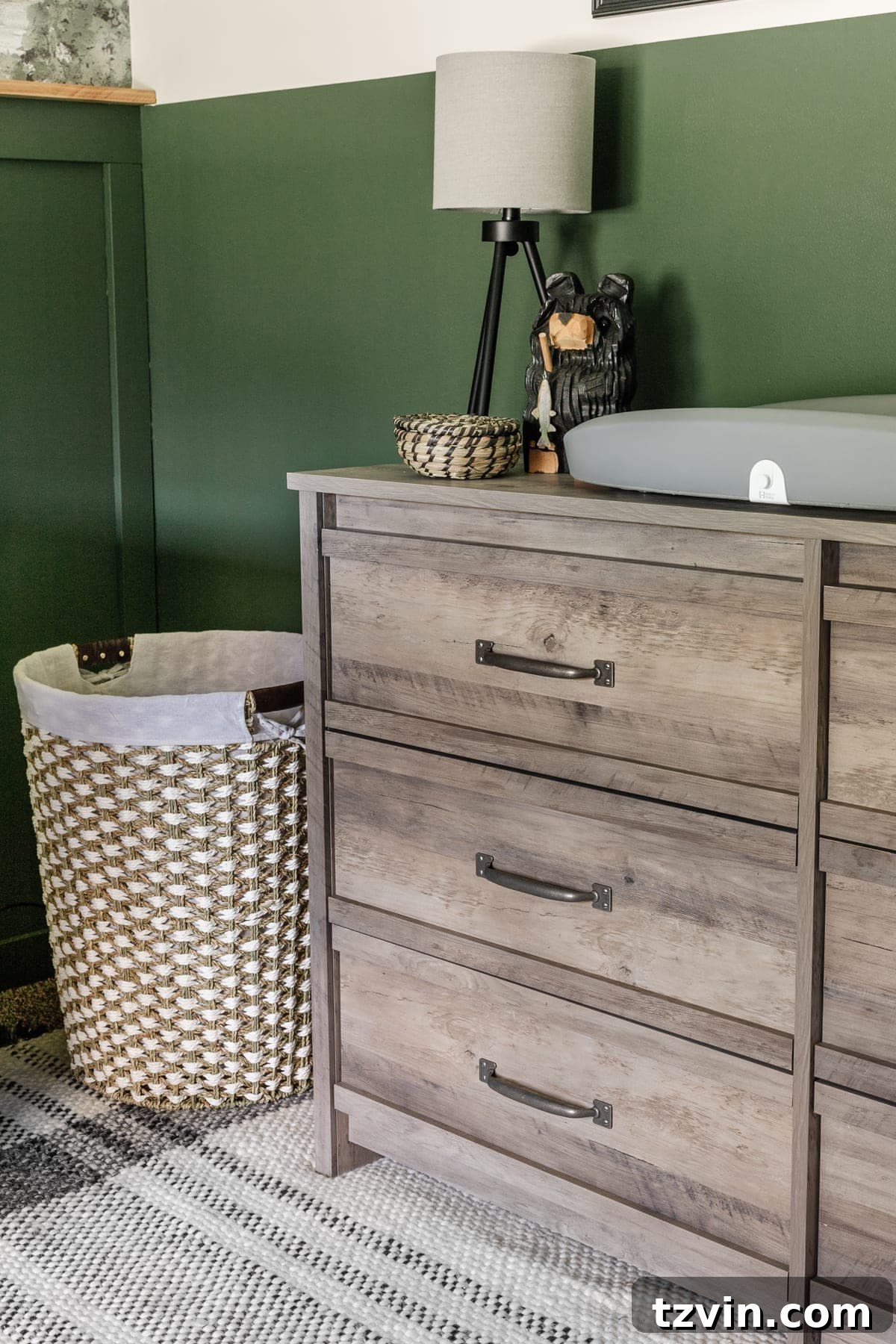 Our Cozy Woodland Wonderland: Baby Boy Nursery Transformation 8 Boy nursery with weathered wood dresser, seagrass hamper, and tripod lamp