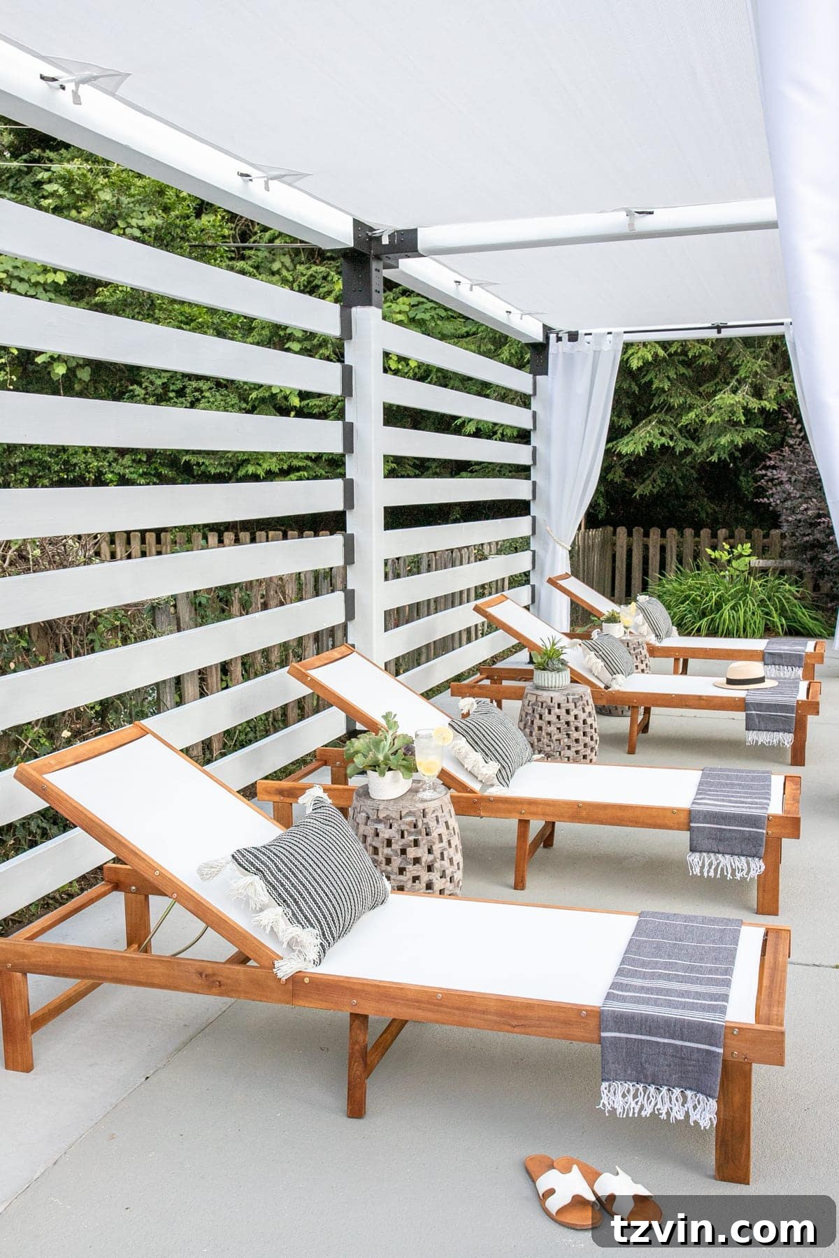 pool lounge chairs under a white DIY pergola
