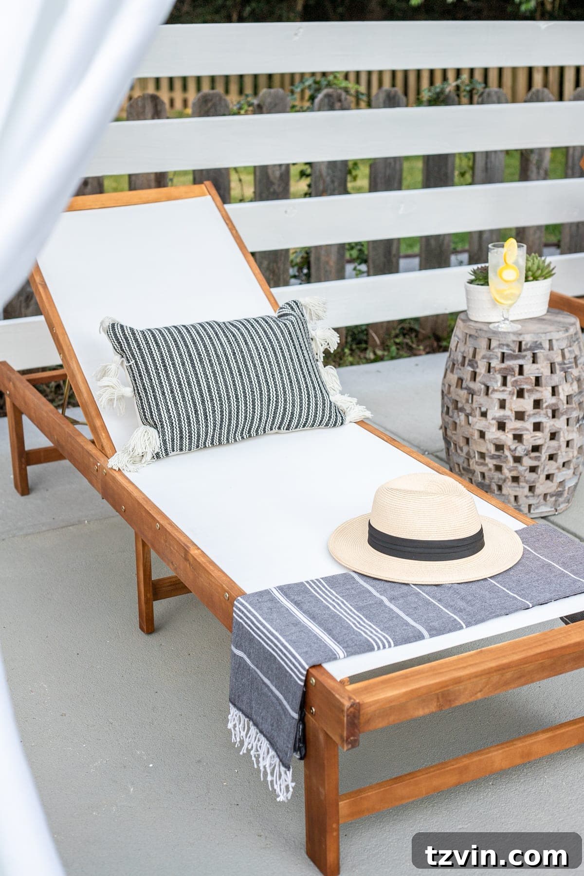 outdoor lounge chair with pillow, turkish towel, and sun hat
