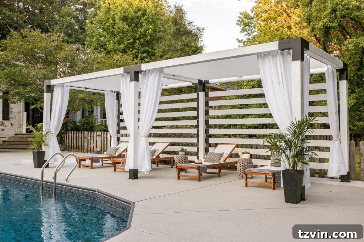 white DIY pergola cabana with outdoor curtains and lounge chairs