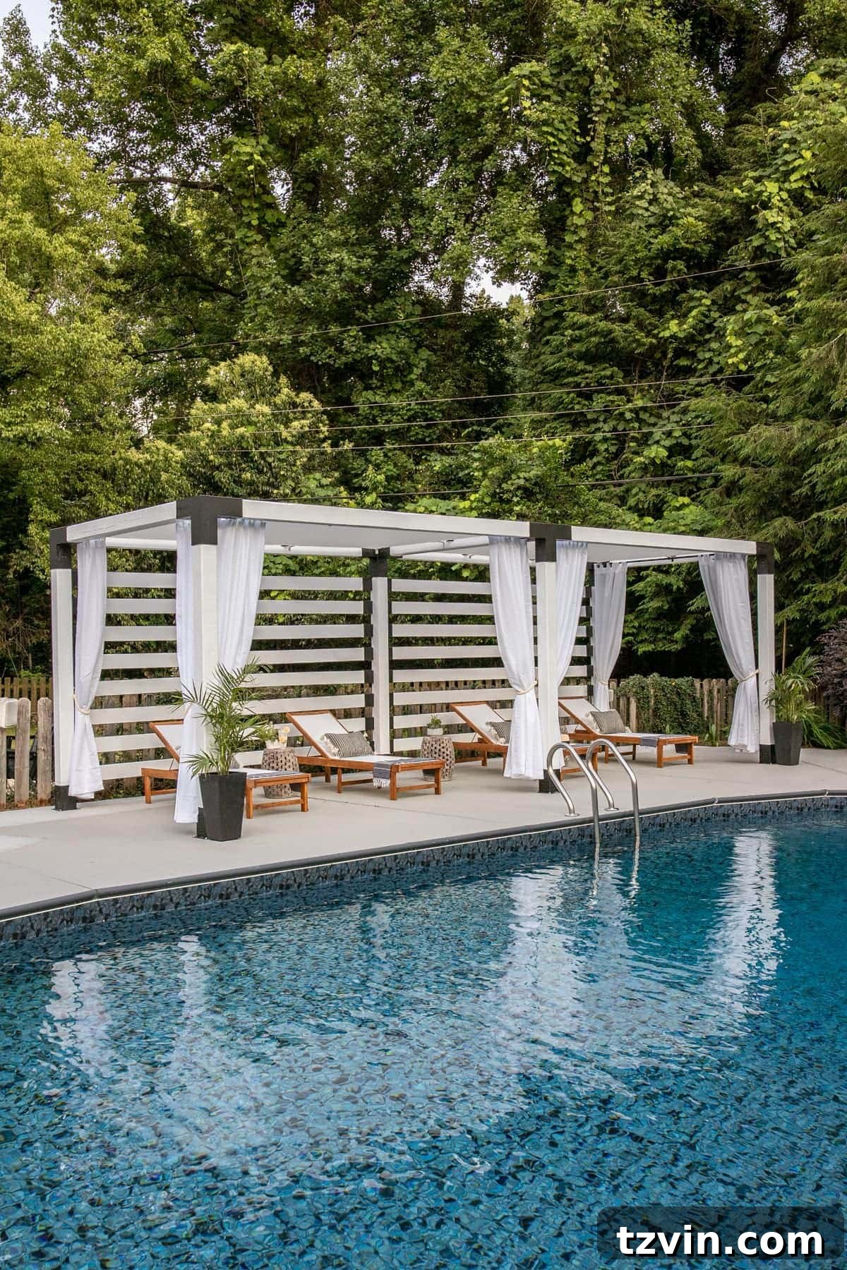 white DIY pergola cabana with outdoor curtains and lounge chairs