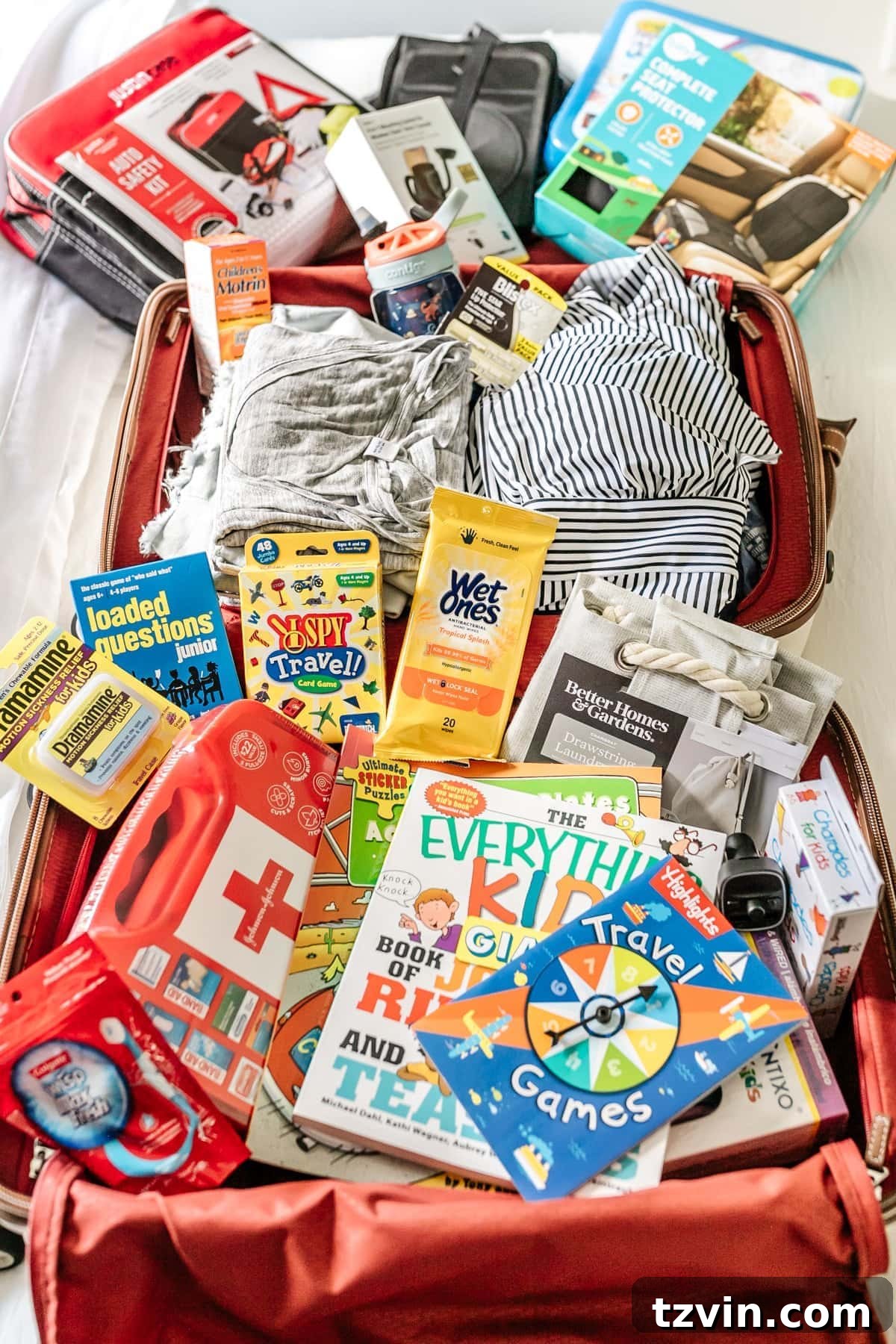 Road Trip Ready: Your Printable Packing Guide 3 A selection of essential road trip items for families, including car organizers, first aid kit, wet wipes, and motion sickness medication.