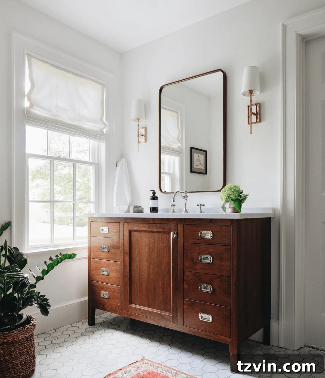 Medium toned wood bathroom vanity with hexagon tile and shaded sconces