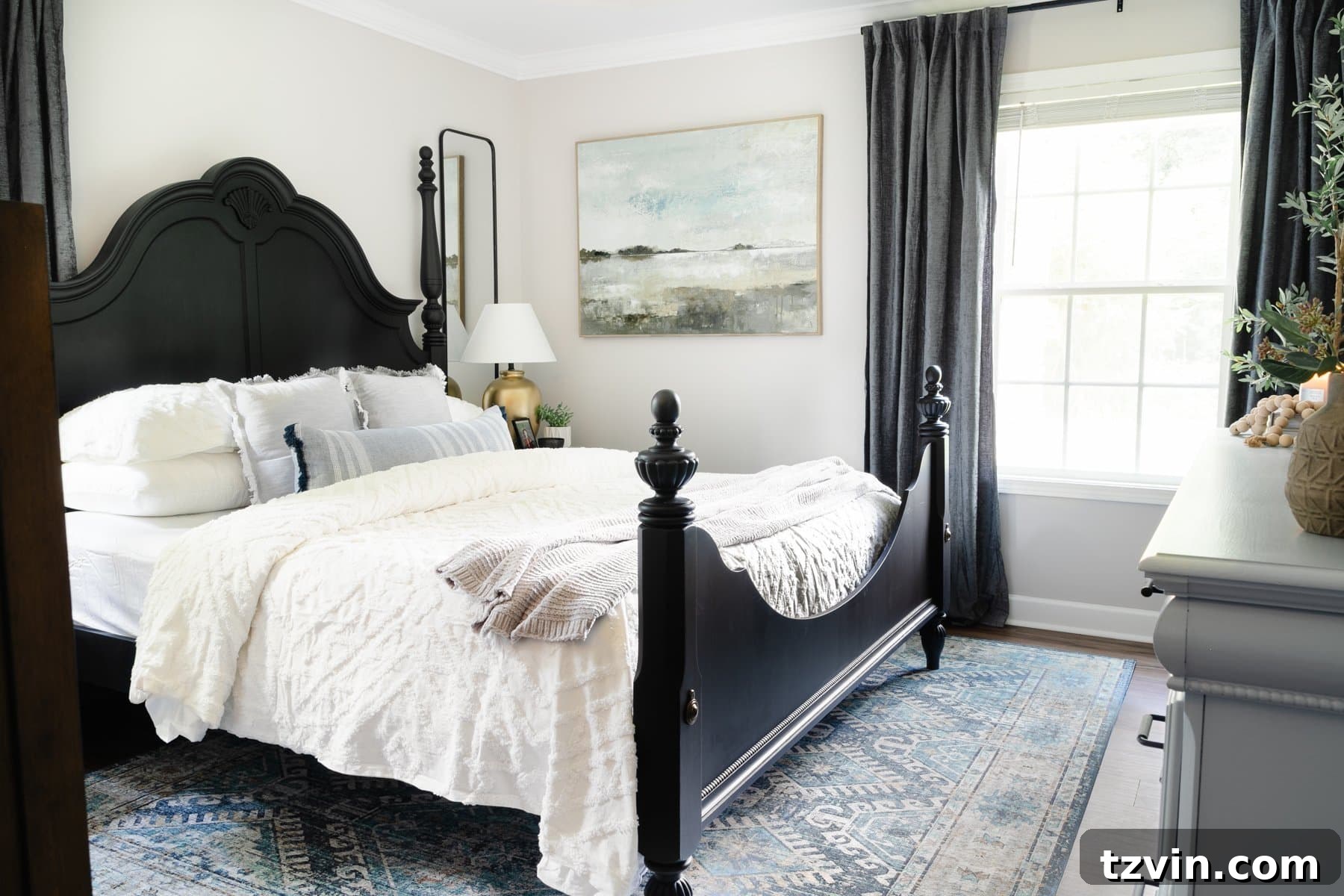 small primary bedroom with black poster bed and gray walls
