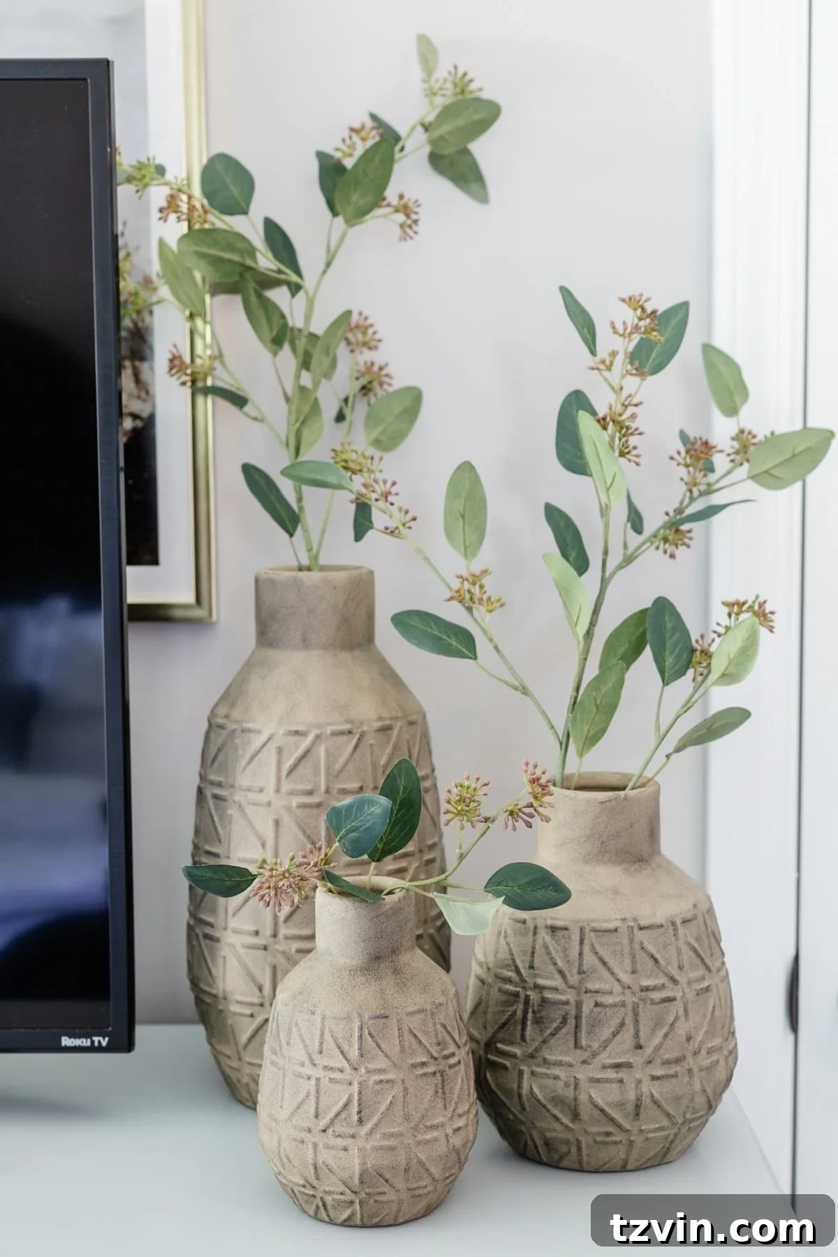 10 Clever Tricks to Make Your Small Bedroom Seem Bigger 14 3 vases with stems on dresser decor in bedroom