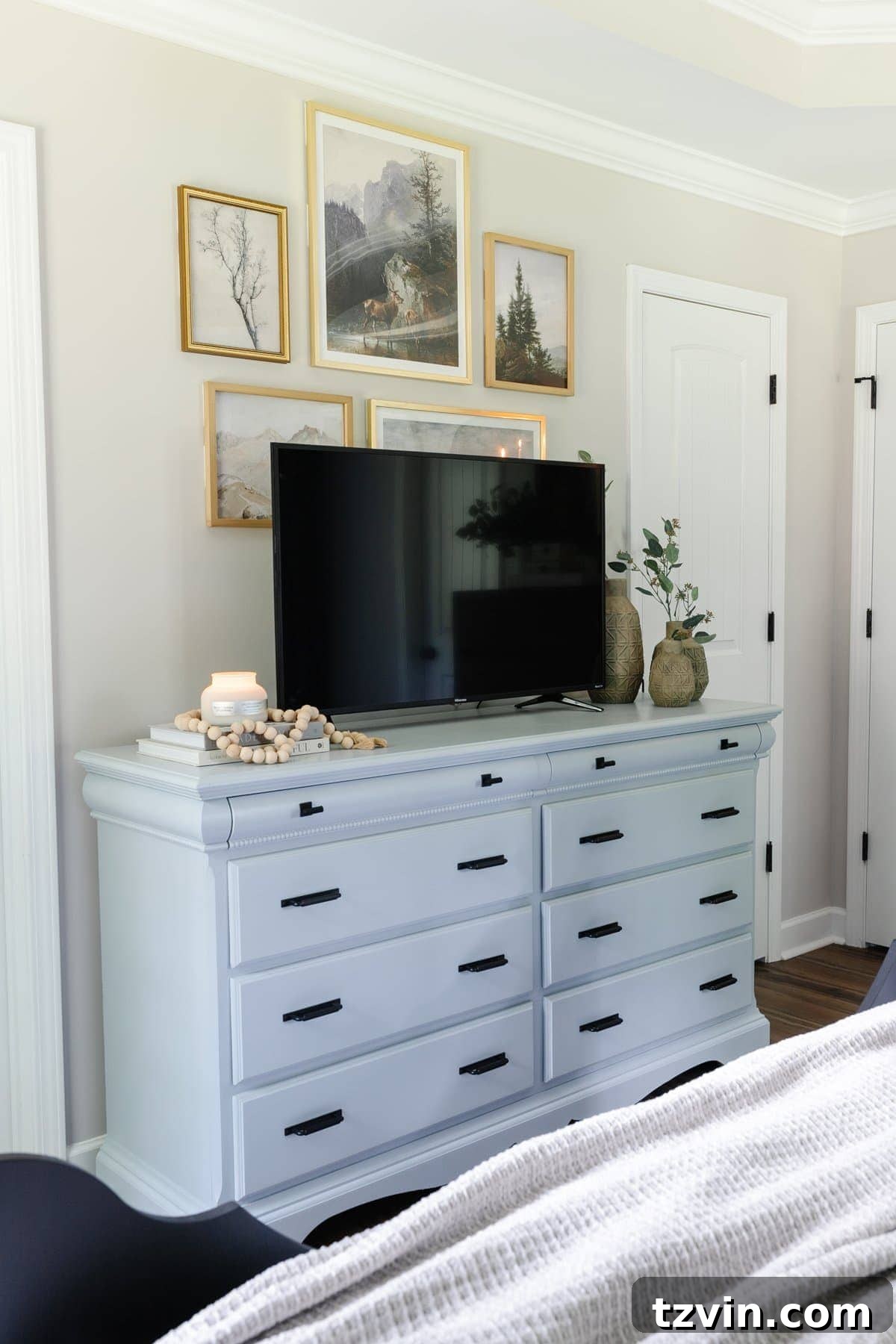 10 Clever Tricks to Make Your Small Bedroom Seem Bigger 4 small bedroom with tv on blue painted dresser and gallery wall decor