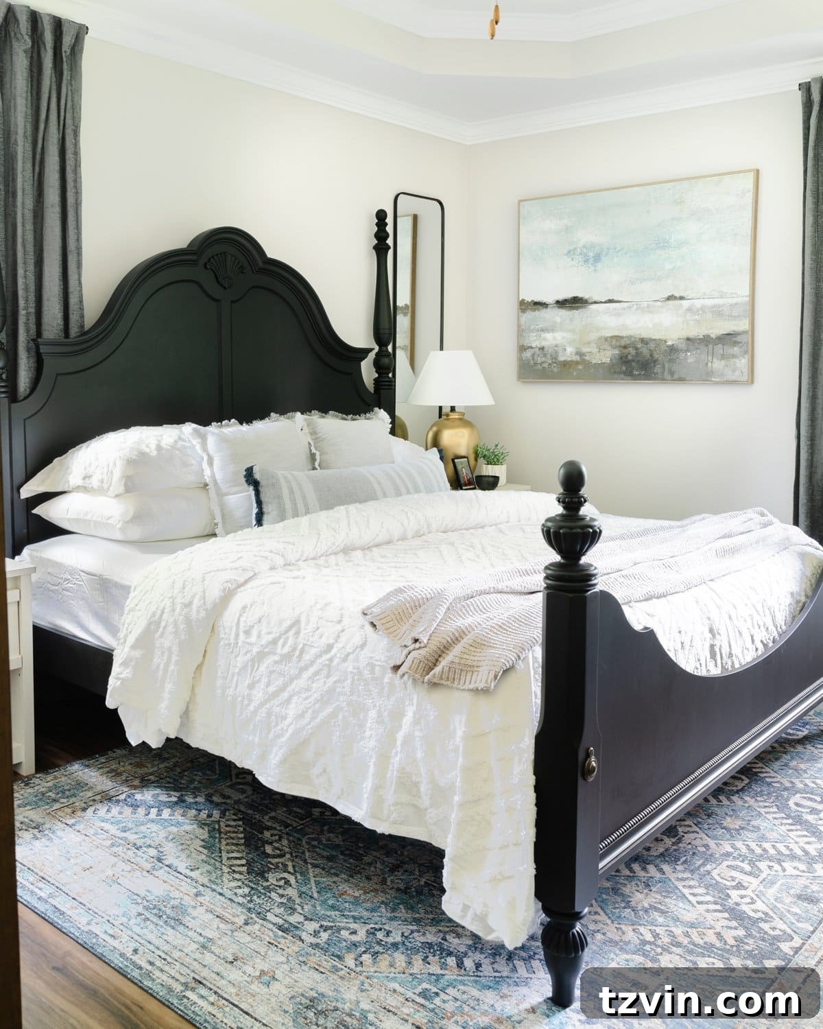 10 Clever Tricks to Make Your Small Bedroom Seem Bigger 6 black poster bed in small bedroom with large wall decor