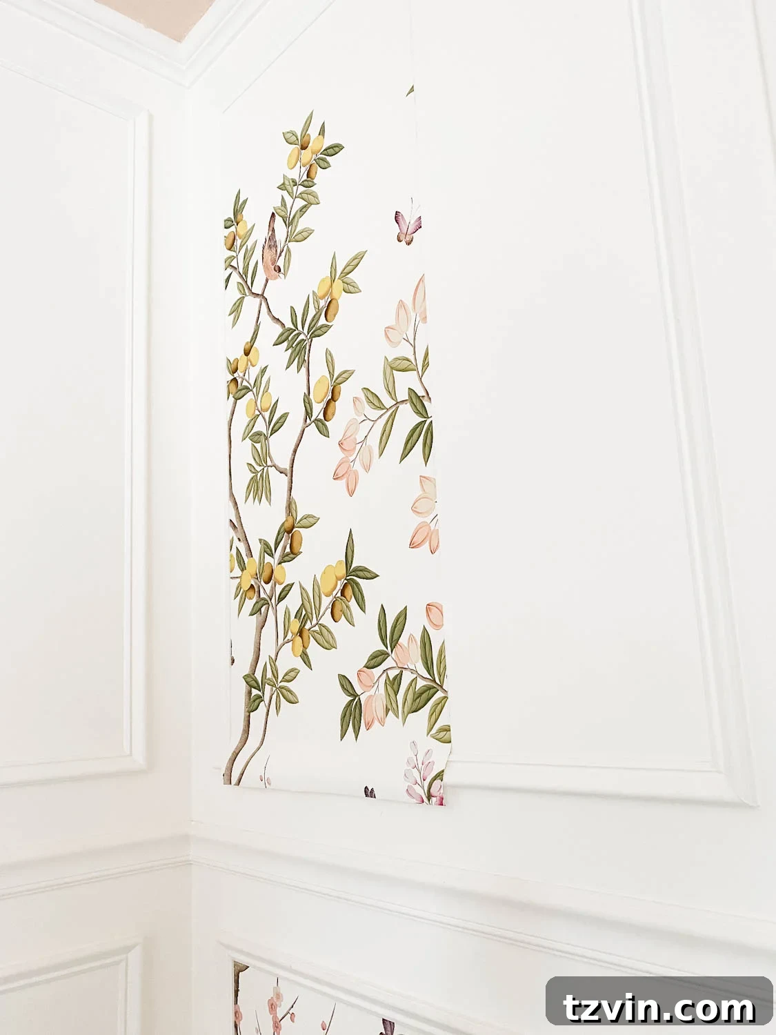 Create a Designer Look: Wallpapering Inside Picture Frame Molding 12 The excess wallpaper overhang visible at the top and bottom edges of the picture frame molding, ready for trimming.
