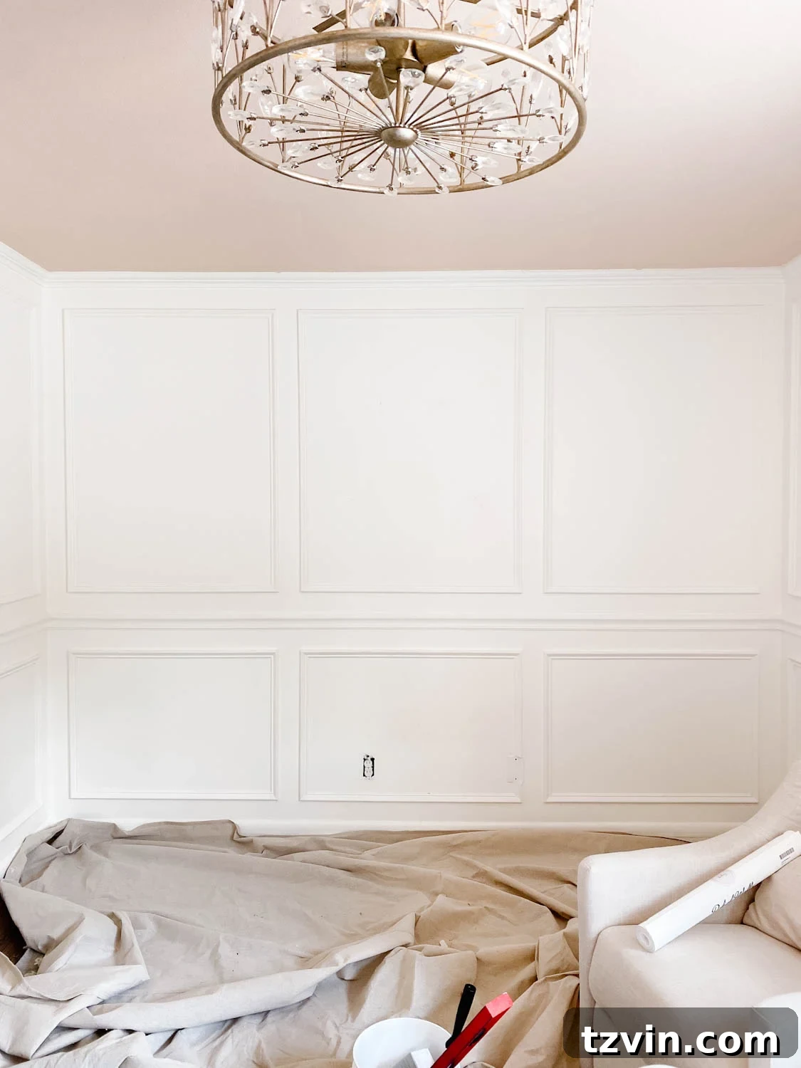 Create a Designer Look: Wallpapering Inside Picture Frame Molding 3 Close-up of elegant picture frame molding painted white against a soft blush ceiling in a girl's bedroom, waiting for wallpaper.