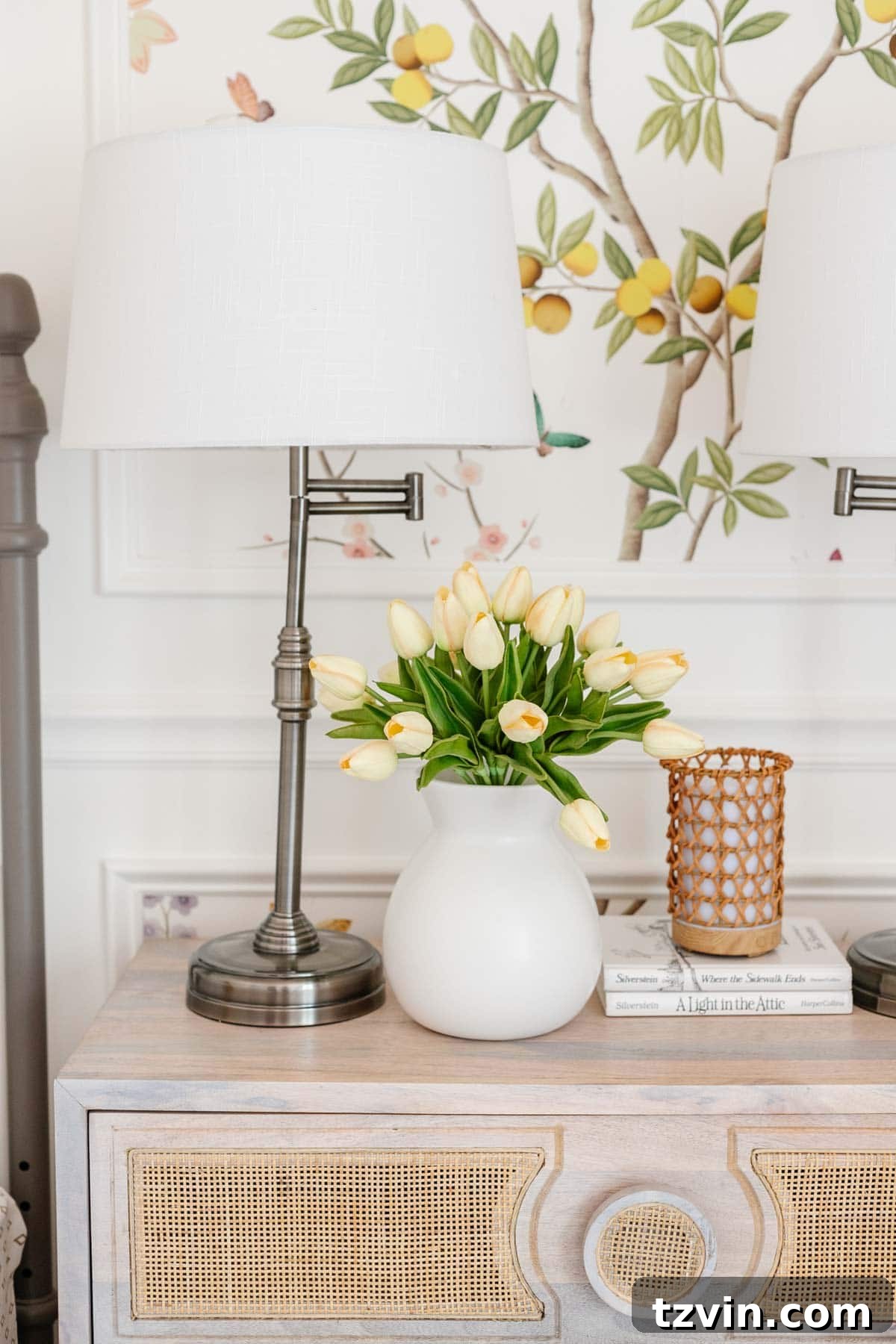 toddler girl room decor with faux flowers, lamp, and diffuser