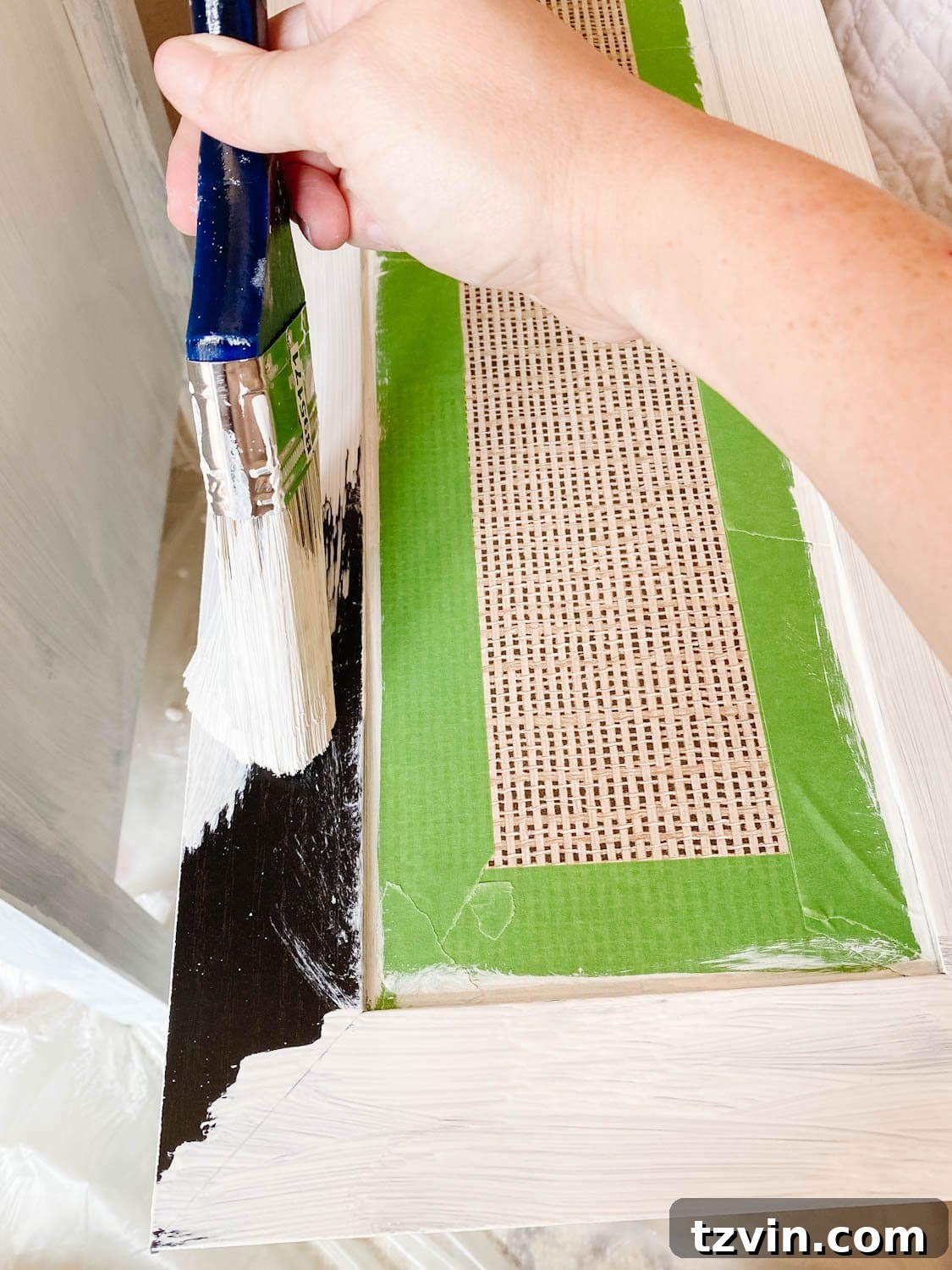 Laminate dresser with a freshly applied coat of oil-based primer, demonstrating the crucial first step for painting.