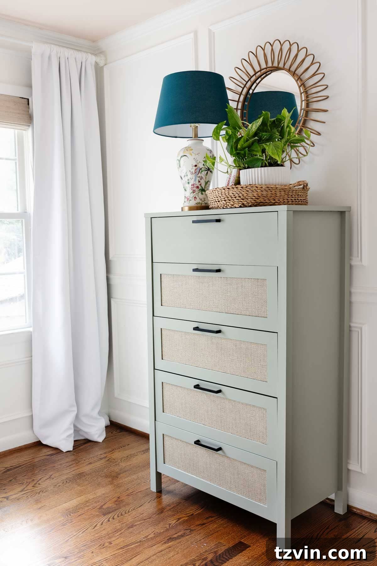 Freshly painted sage green laminate dresser in a beautifully decorated little girl's bedroom, showcasing the successful makeover.