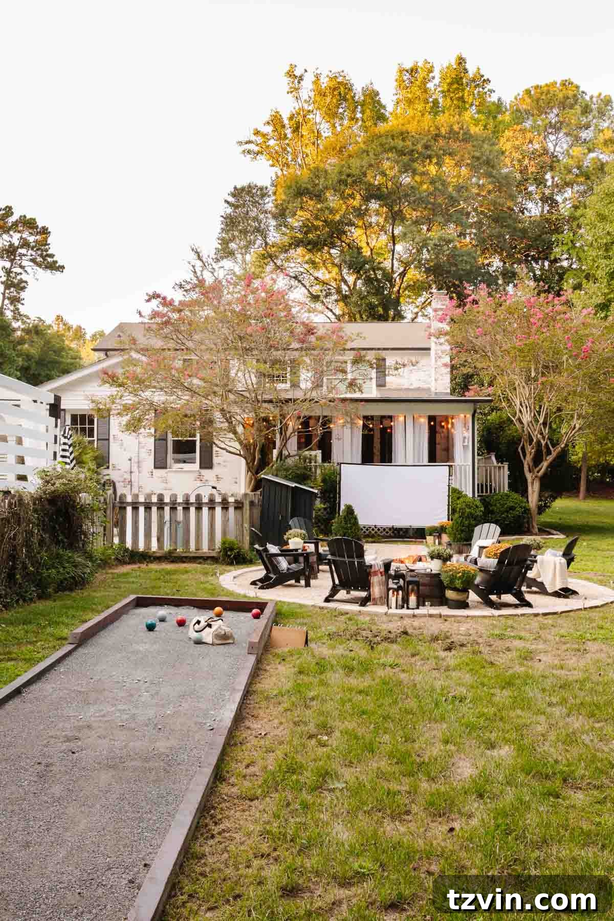 Ignite Autumn Nights: 8 Fire Pit Decor Ideas for Your Backyard 15 Backyard fire pit area with a bocce ball court, ideal for fall outdoor entertaining
