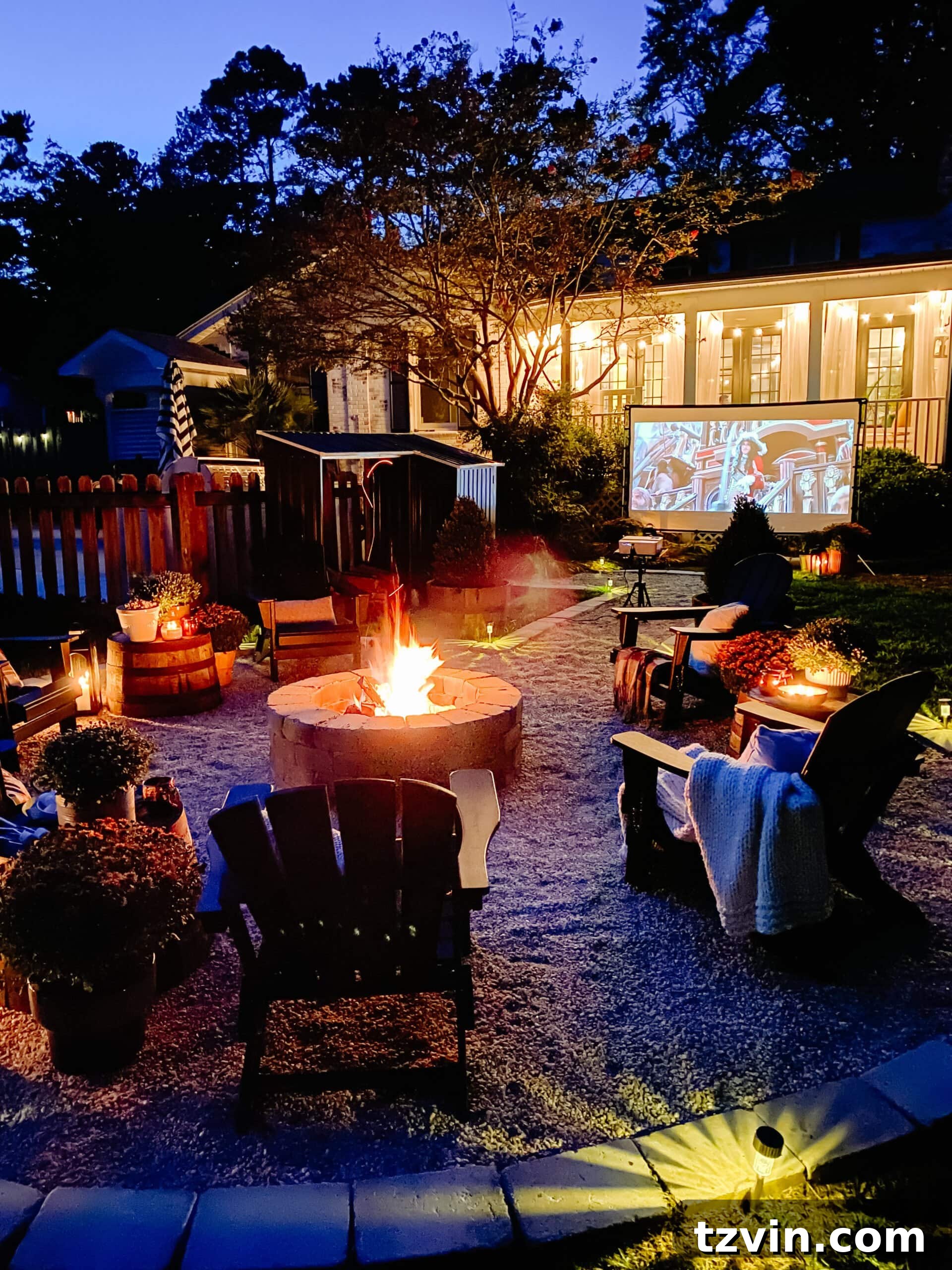 Ignite Autumn Nights: 8 Fire Pit Decor Ideas for Your Backyard 17 Backyard fire pit ideas: A vibrant outdoor movie theater setup with fall decor