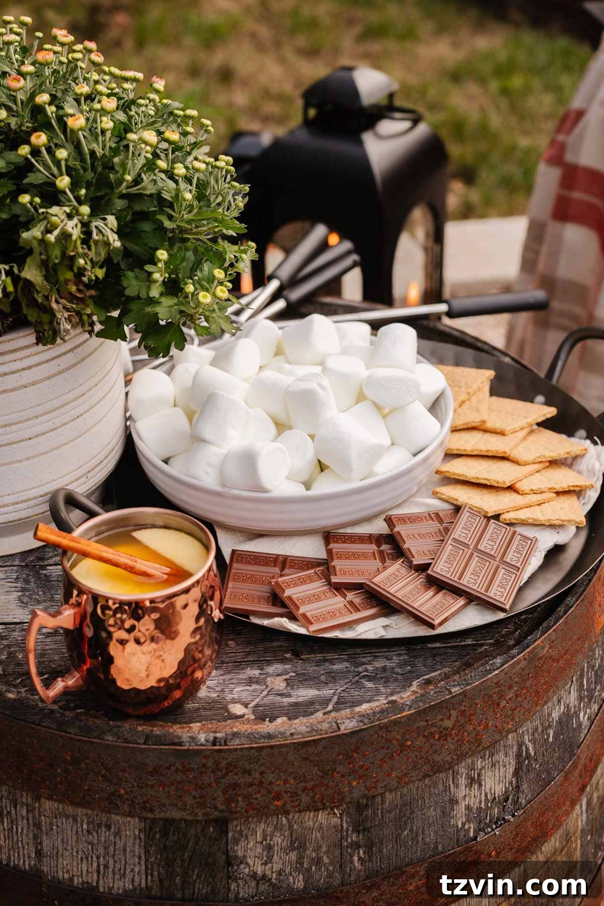 Ignite Autumn Nights: 8 Fire Pit Decor Ideas for Your Backyard 10 S'mores station and copper mugs with cider, perfect for a backyard fire pit party
