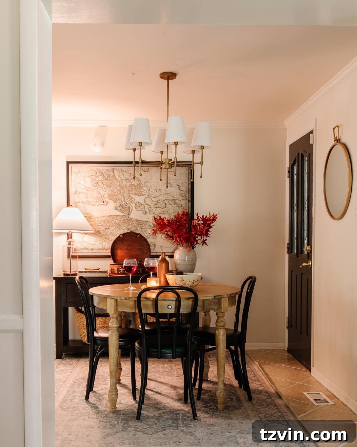 A beautifully decorated cozy dining room set for fall with warm lighting, candles, and a stylish dining table, perfect for enjoying a relaxing evening.