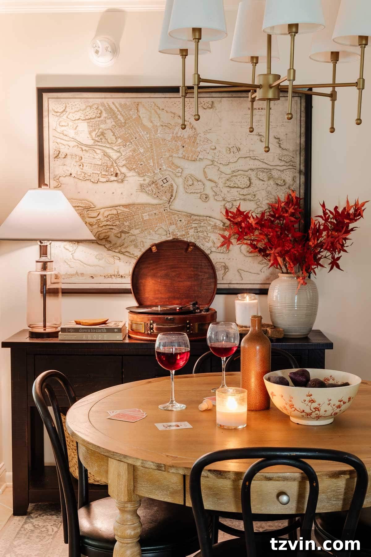 A warm and inviting dining room lit by lamps, featuring elegant fall decor, embodying a cozy and relaxed home environment.