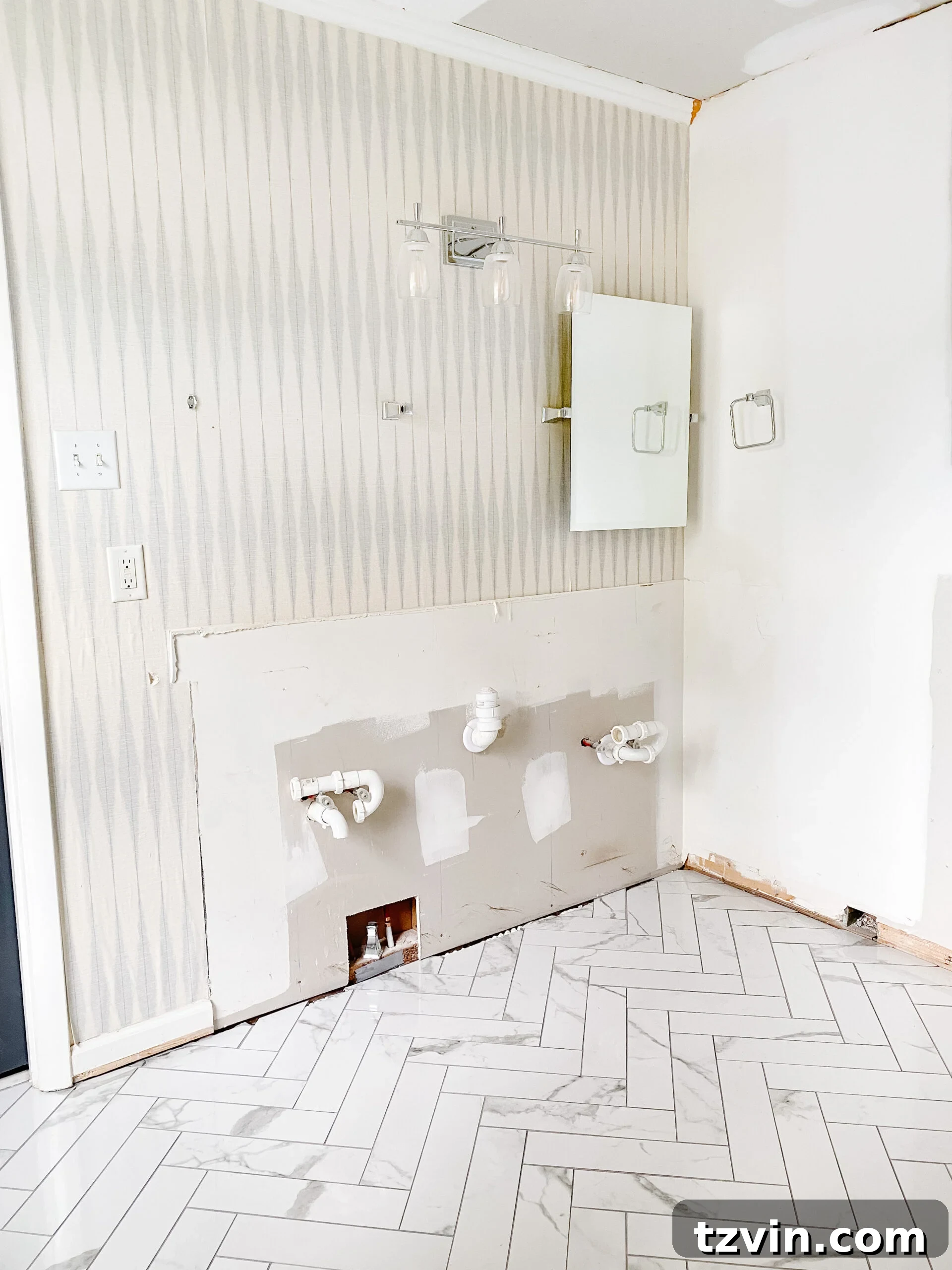 Our Faux Marble Herringbone Shower Transformation 11 faux marble herringbone tile floor installed in a bathroom awaiting further renovation