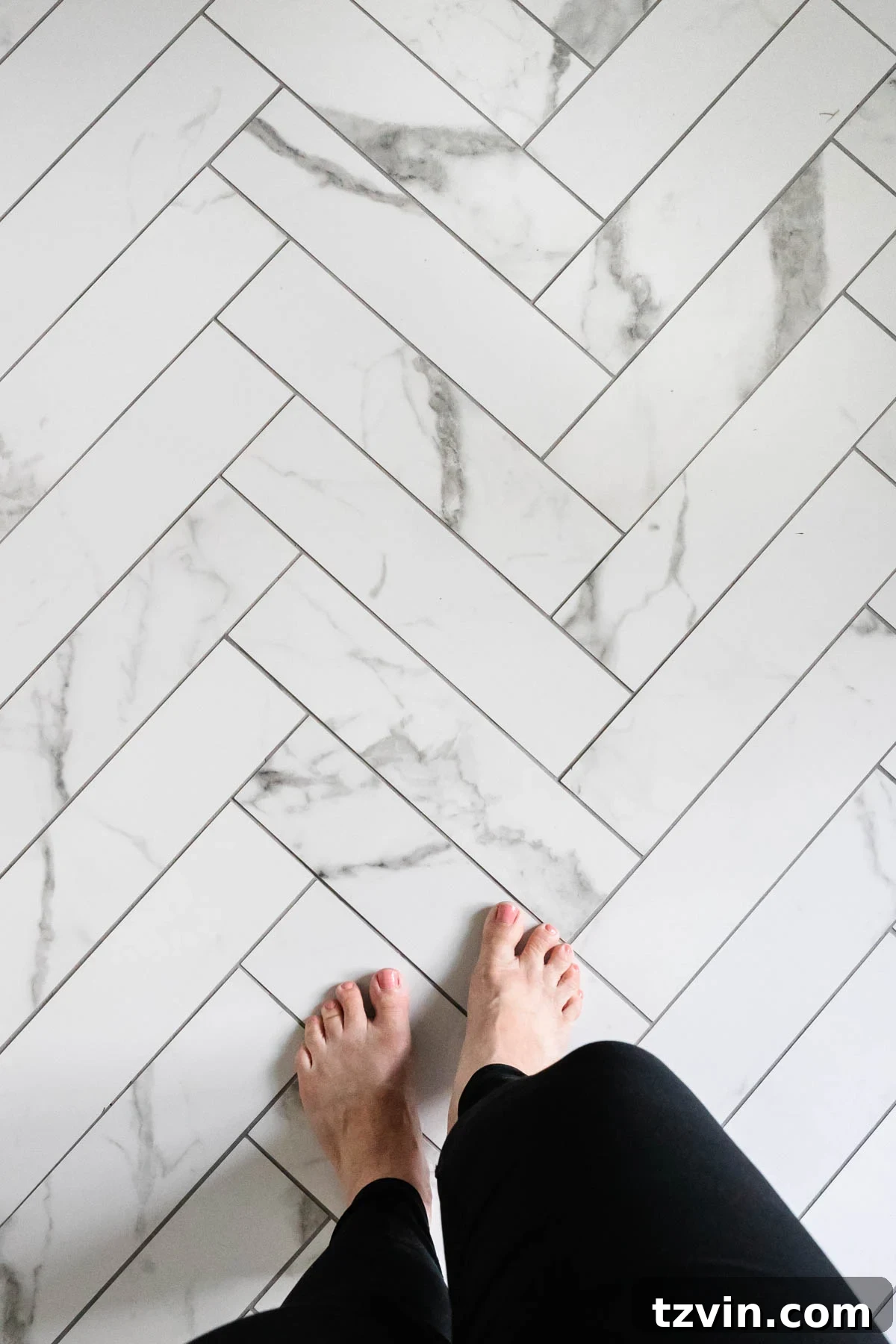 Our Faux Marble Herringbone Shower Transformation 8 close-up of faux marble herringbone tile floor with chosen gray grout