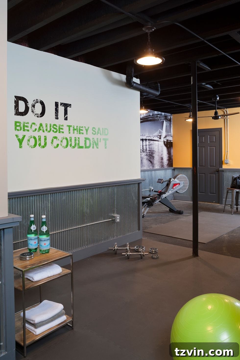 Smart Home Gym Solutions for Basements Garages and Sheds 16 home gym with a shelf, industrial lighting, and a wall quote mural