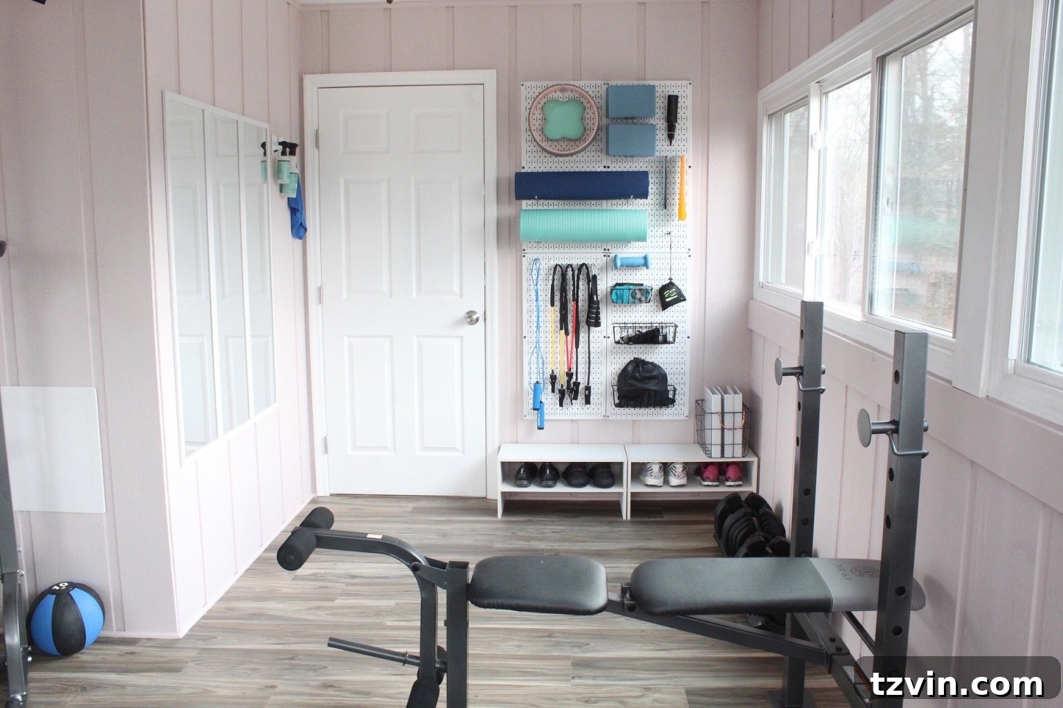 Smart Home Gym Solutions for Basements Garages and Sheds 9 workout room with a wall organizer pegboard for small workout equipment