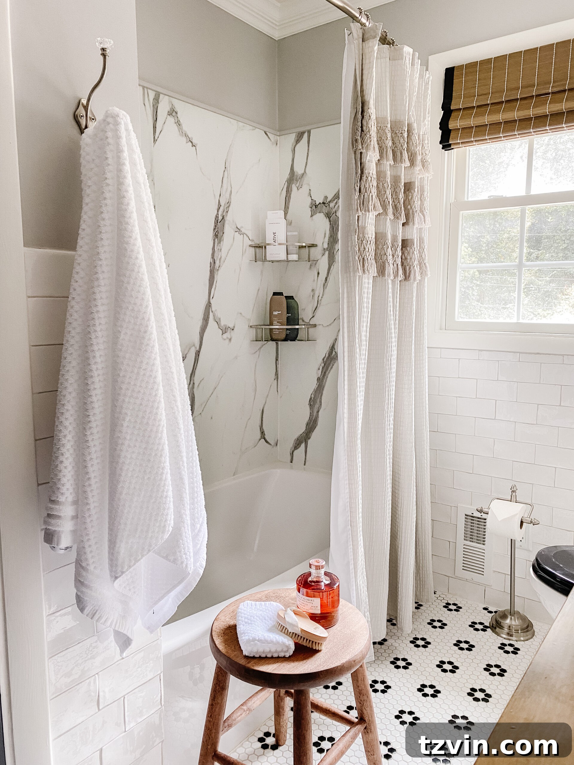 Monochrome Bathroom Makeover for Timeless Style 15 marble shower with black and white retro tile and gray shower curtain