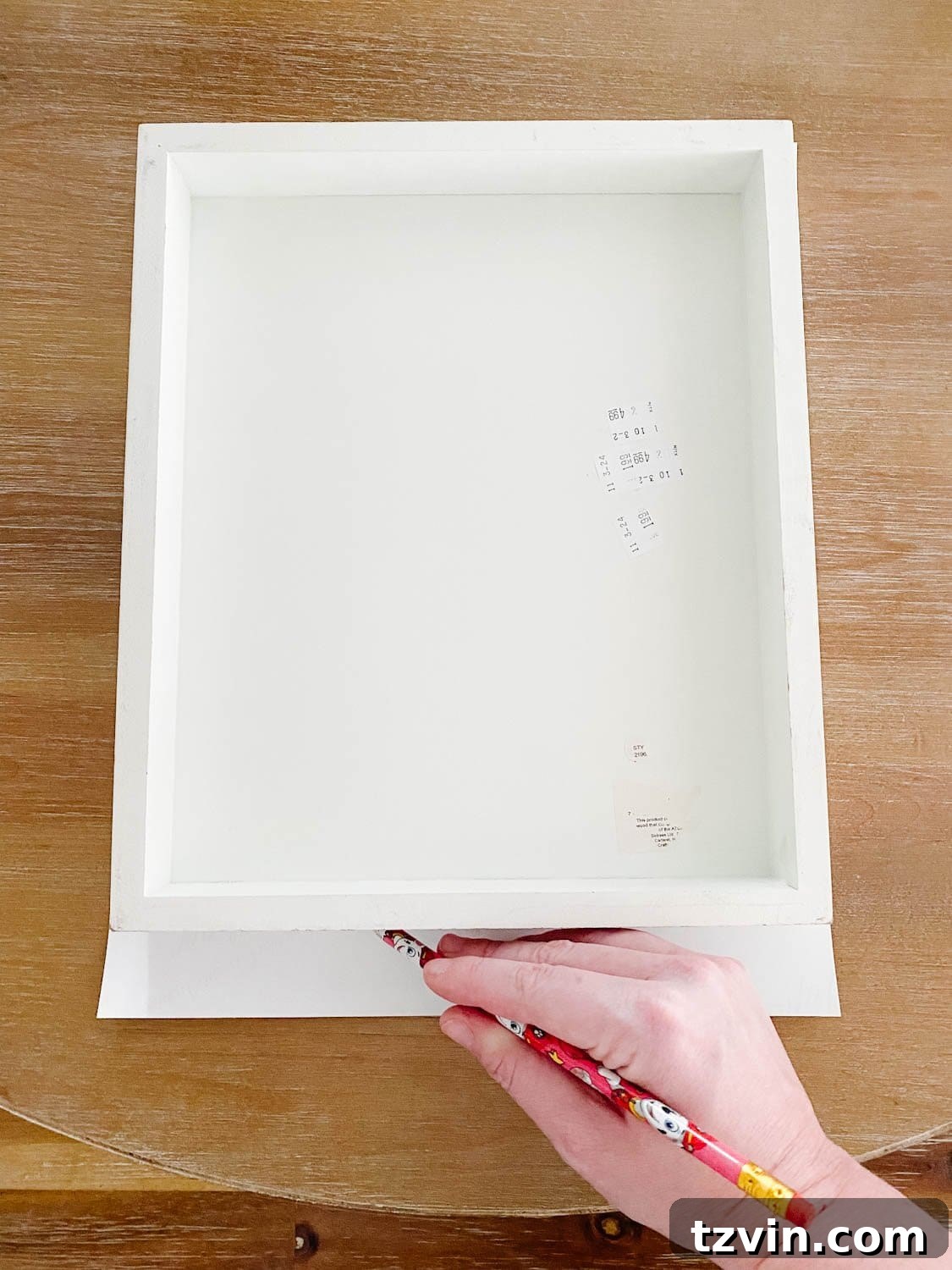 Crafting Vintage Canvas Decor from Salvaged Farmhouse Signs 4 tracing a frame onto a vintage art print to trim