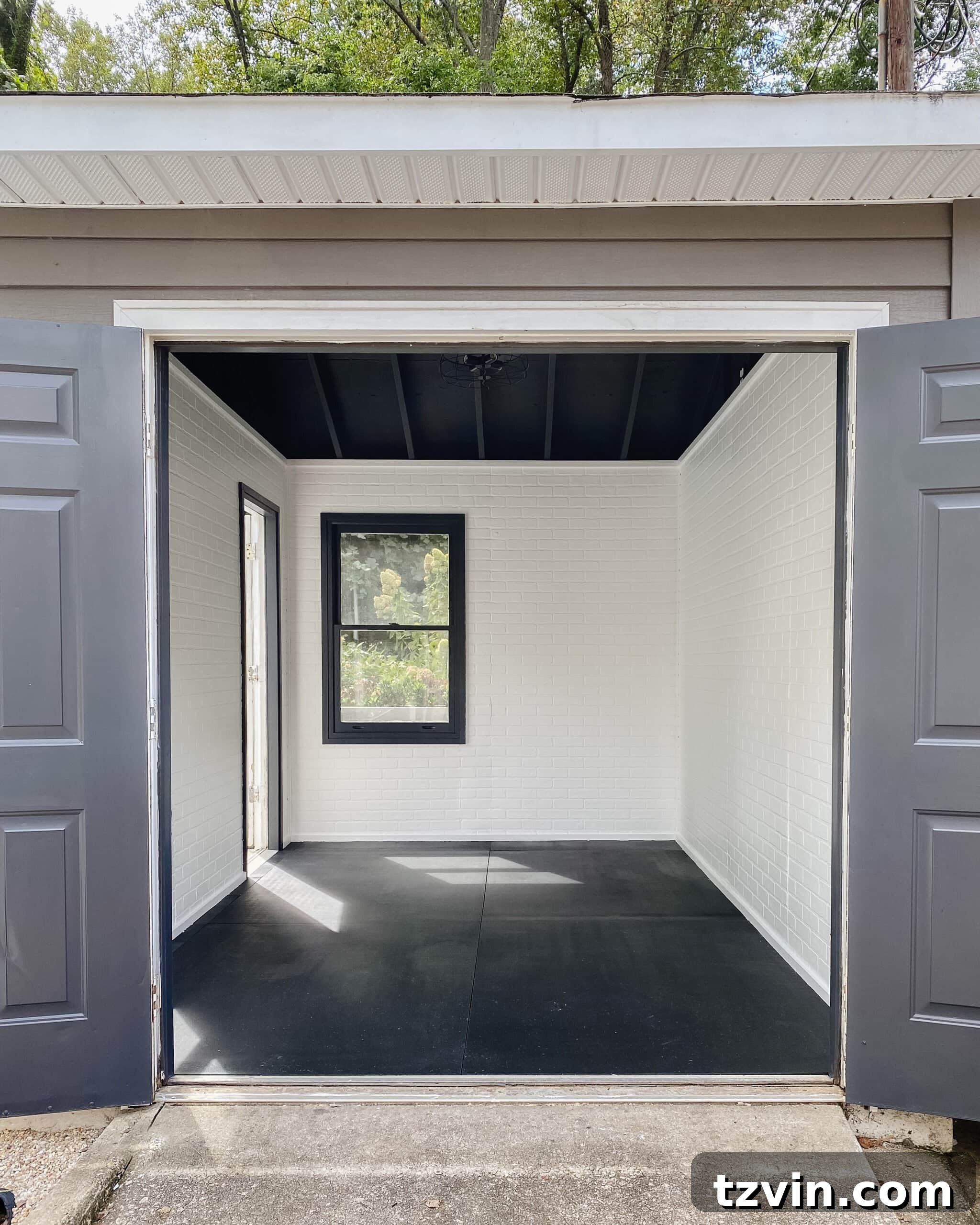 Faux Brick Gym Shed Upgrade 2 Modern industrial gym shed with crisp white faux brick walls, a sleek black ceiling, and industrial lighting, showcasing the dramatic transformation.