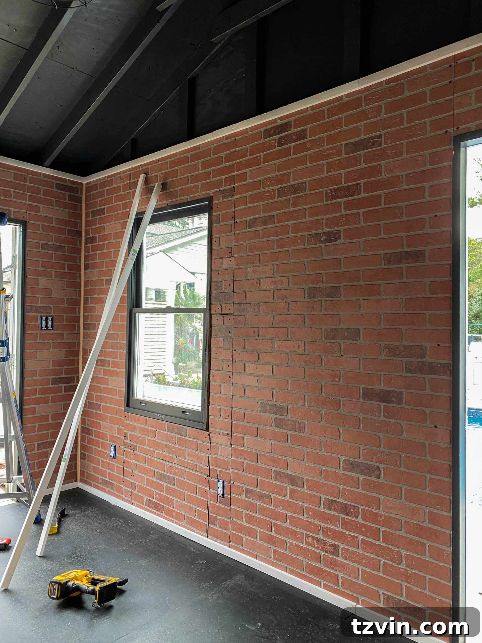 Faux Brick Gym Shed Upgrade 11 Detail shot of a faux brick wall with 1x2 trim boards being installed at the top and bottom edges, showcasing the finishing touches.