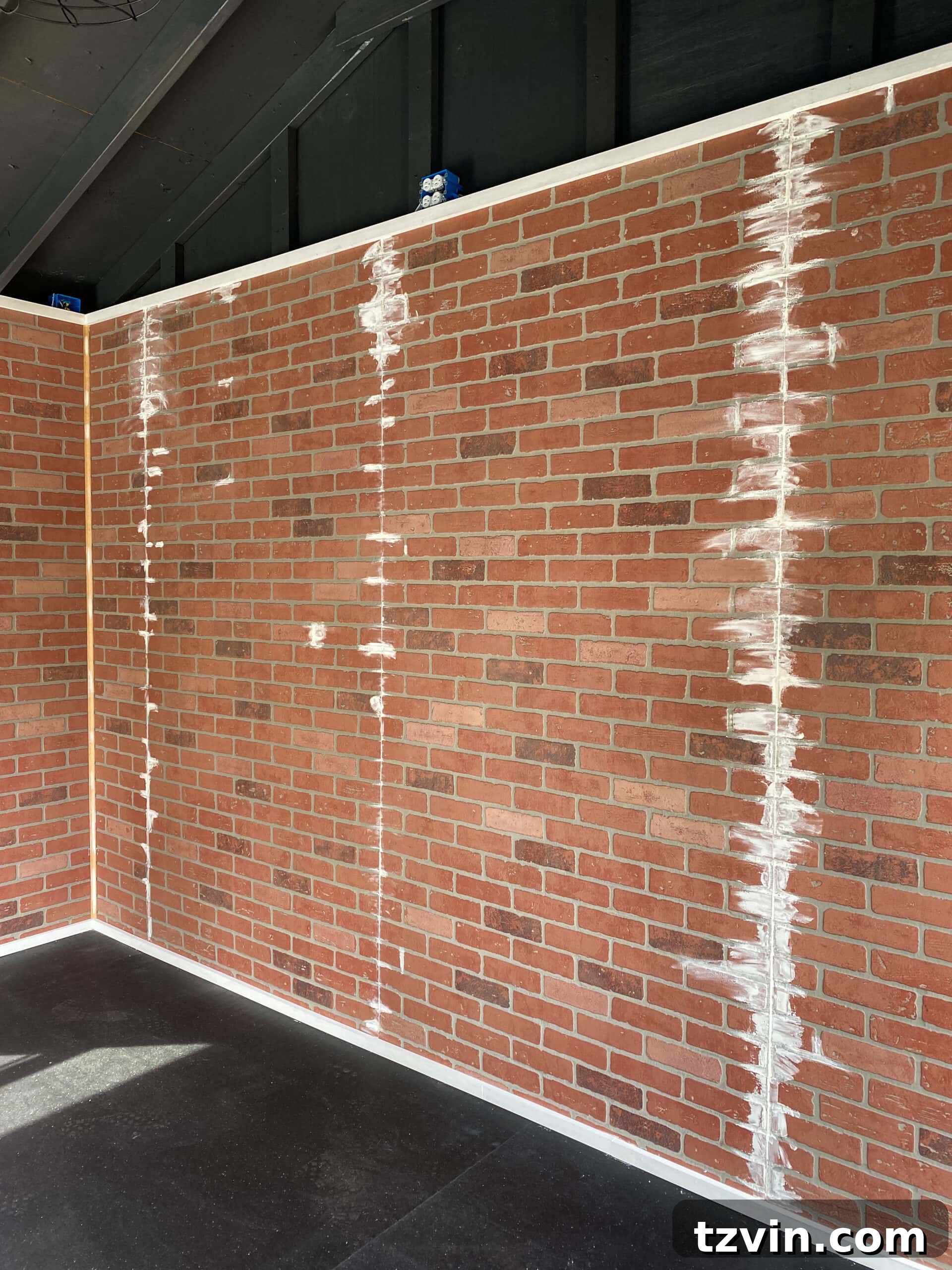 Faux Brick Gym Shed Upgrade 12 Close-up of faux brick wall panels being spackled, demonstrating the process of filling imperfections for a smooth finish.