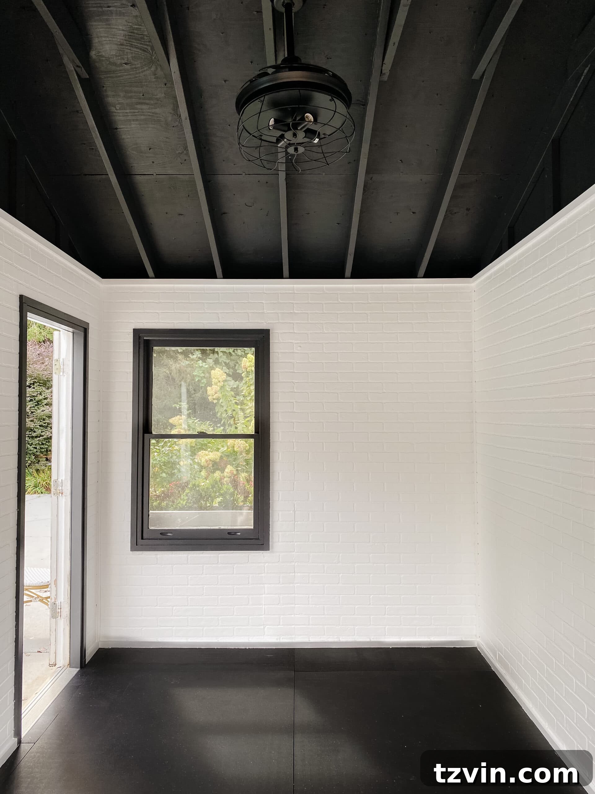 Faux Brick Gym Shed Upgrade 15 Fully finished home gym shed with white faux brick walls, a stylish black ceiling, and ample space for fitness equipment.