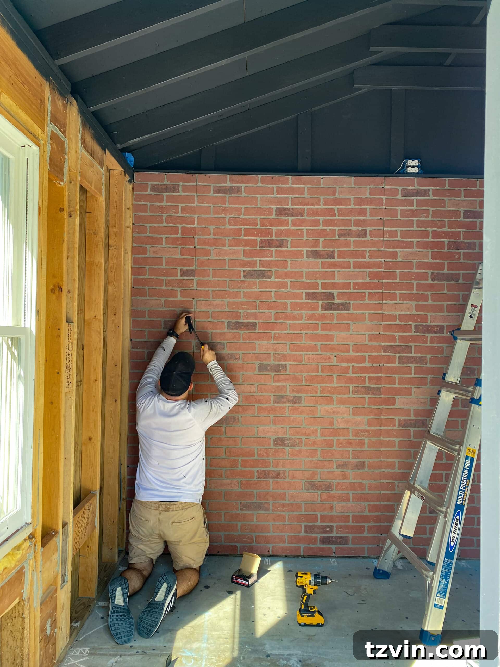 Faux Brick Gym Shed Upgrade 10 Two individuals working together to cut and install faux brick wall panels, demonstrating the alignment process.