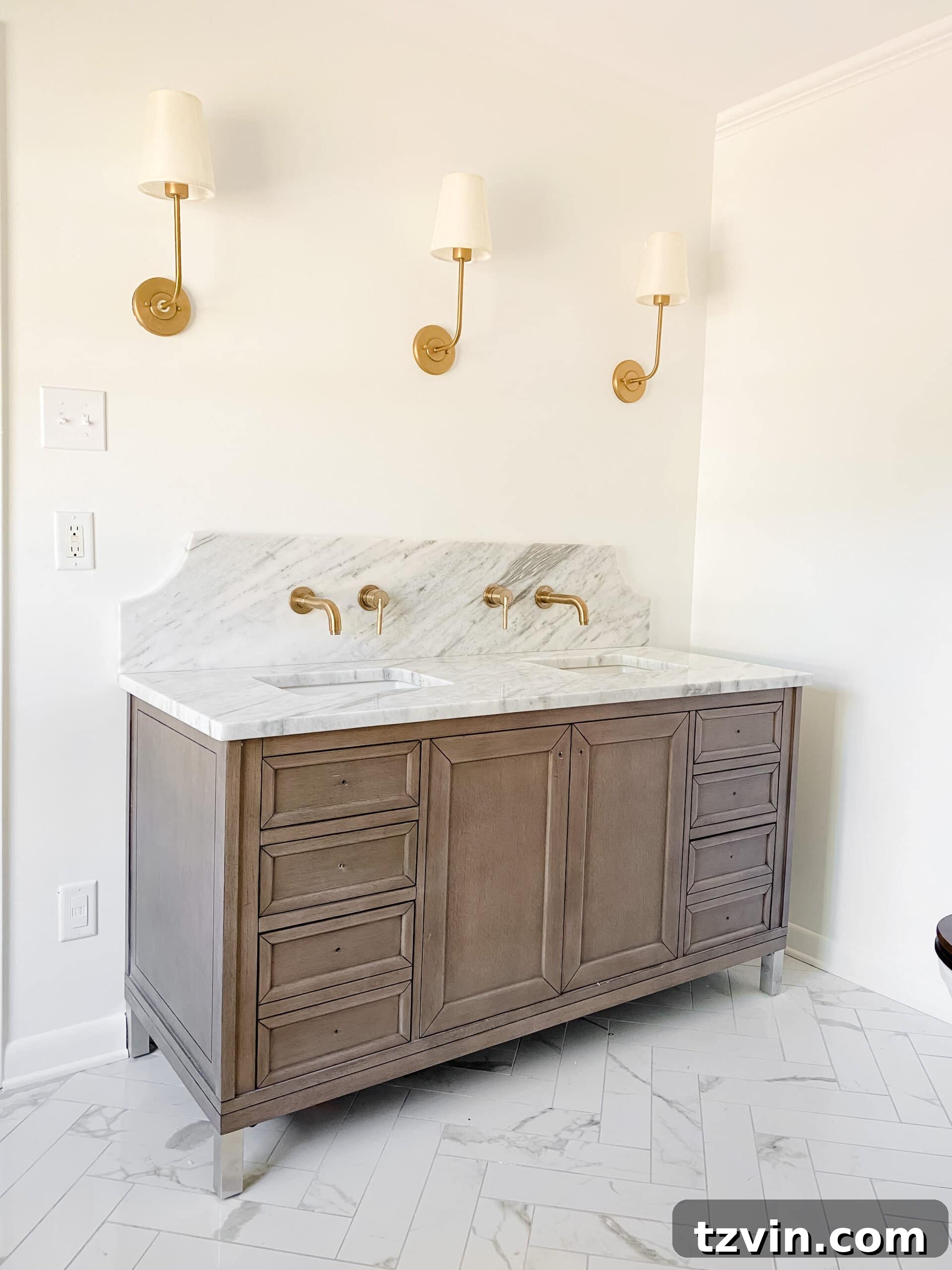 En Suite Bathroom Renovation: Faucets Are Finally Here! 11 A stylish wood bathroom vanity paired with a distinctive scalloped marble backsplash, highlighting the elegant design of the en suite.