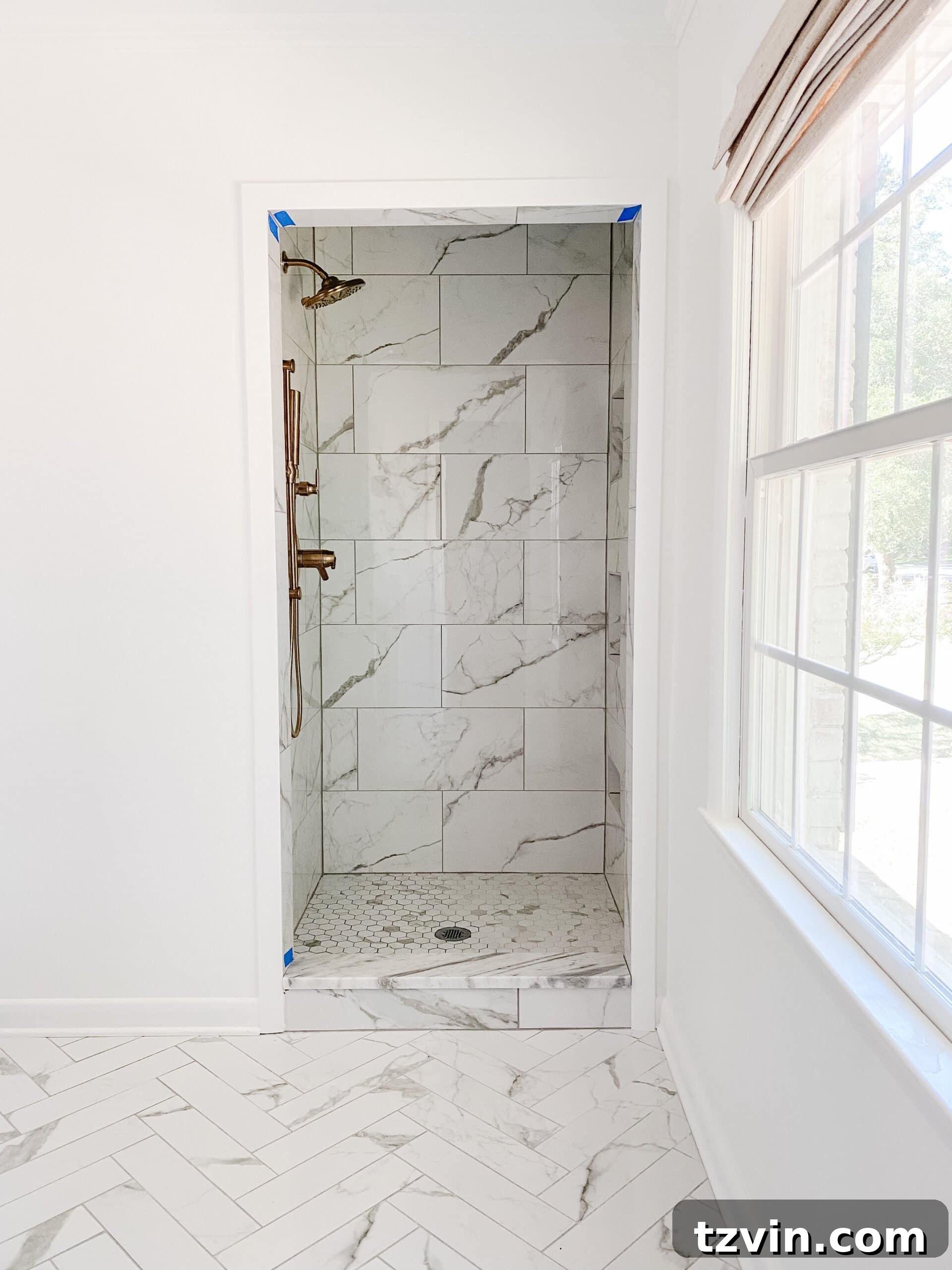 En Suite Bathroom Renovation: Faucets Are Finally Here! 10 An expansive view of the elegant faux marble porcelain tile shower in the classic en suite bathroom.