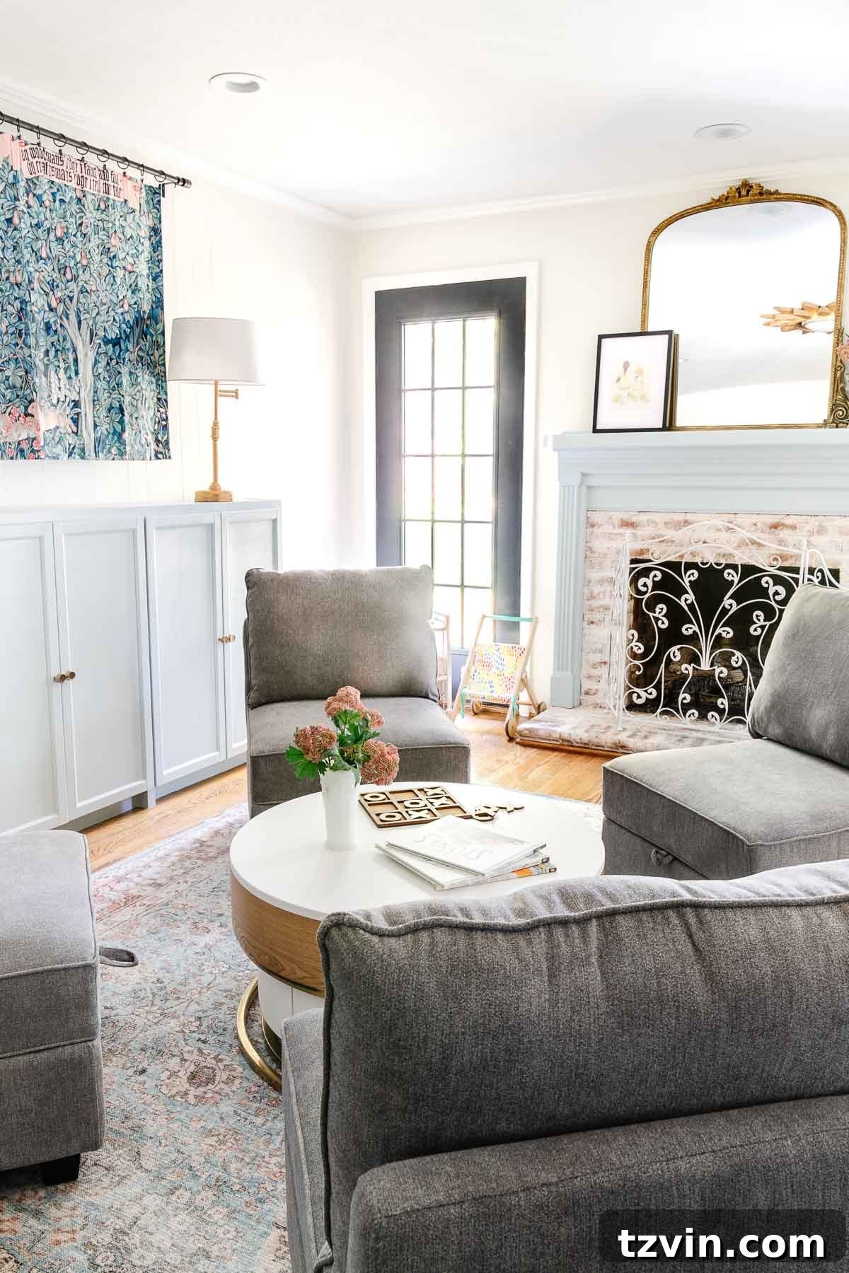 Spill-Proof Chic: 20 Must-Have Machine-Washable Rugs 3 A cozy and organized playroom featuring a fireplace, built-in toy storage cabinets, and a stylish, functional washable rug underfoot, designed for family living.