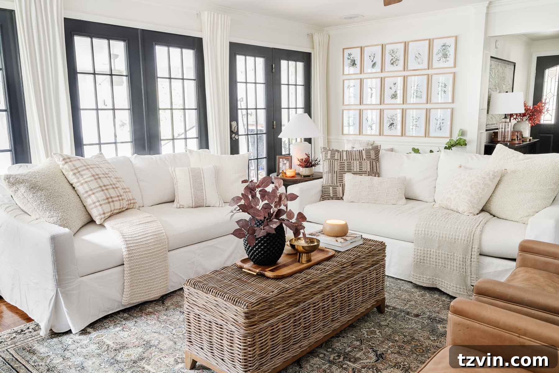 pottery barn sofas in living room with white walls and black windows