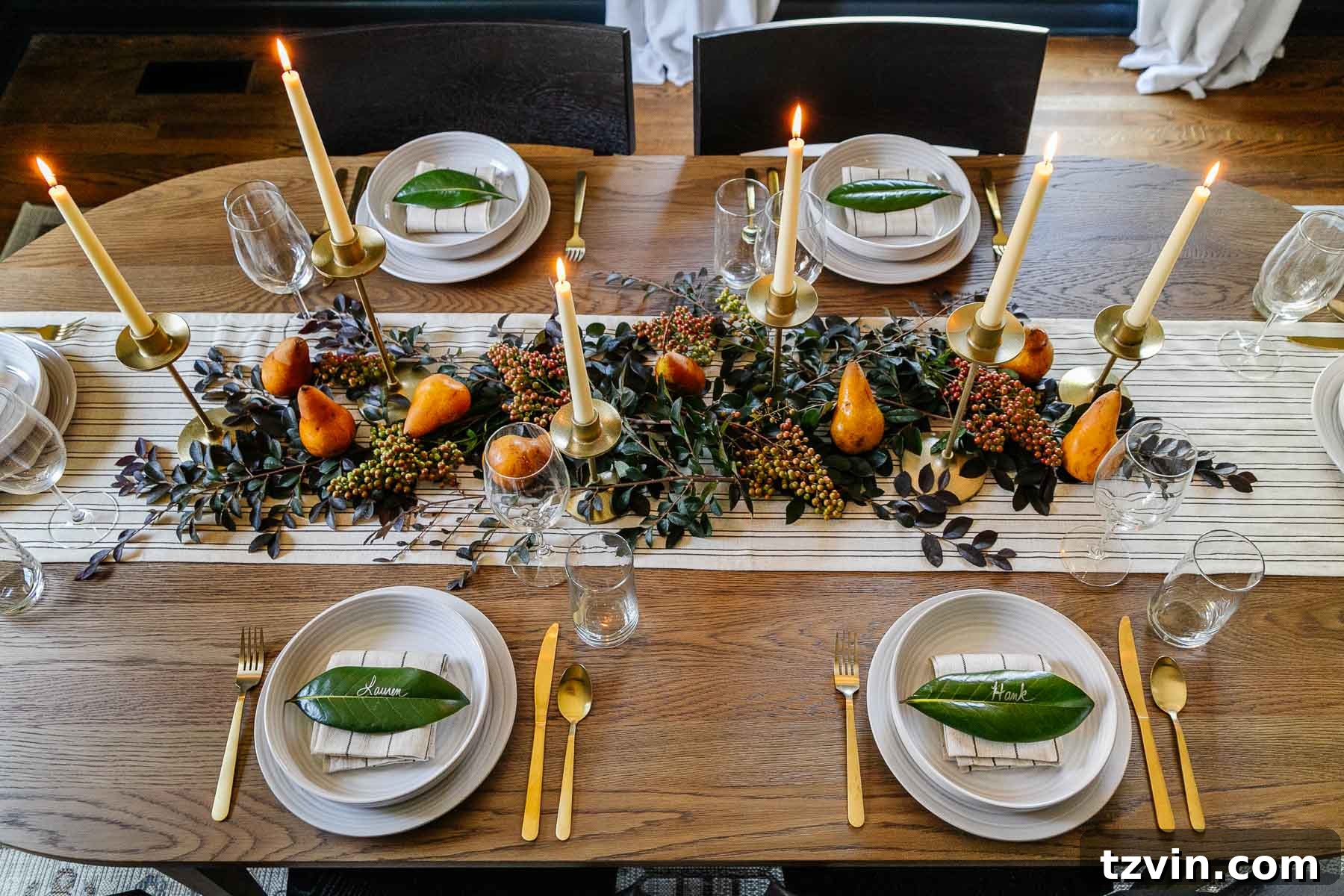 10-Minute Thanksgiving Table Makeover 5 Arranging fresh cut leafy stems around taper candles and Bosc pears for a rustic Thanksgiving centerpiece.