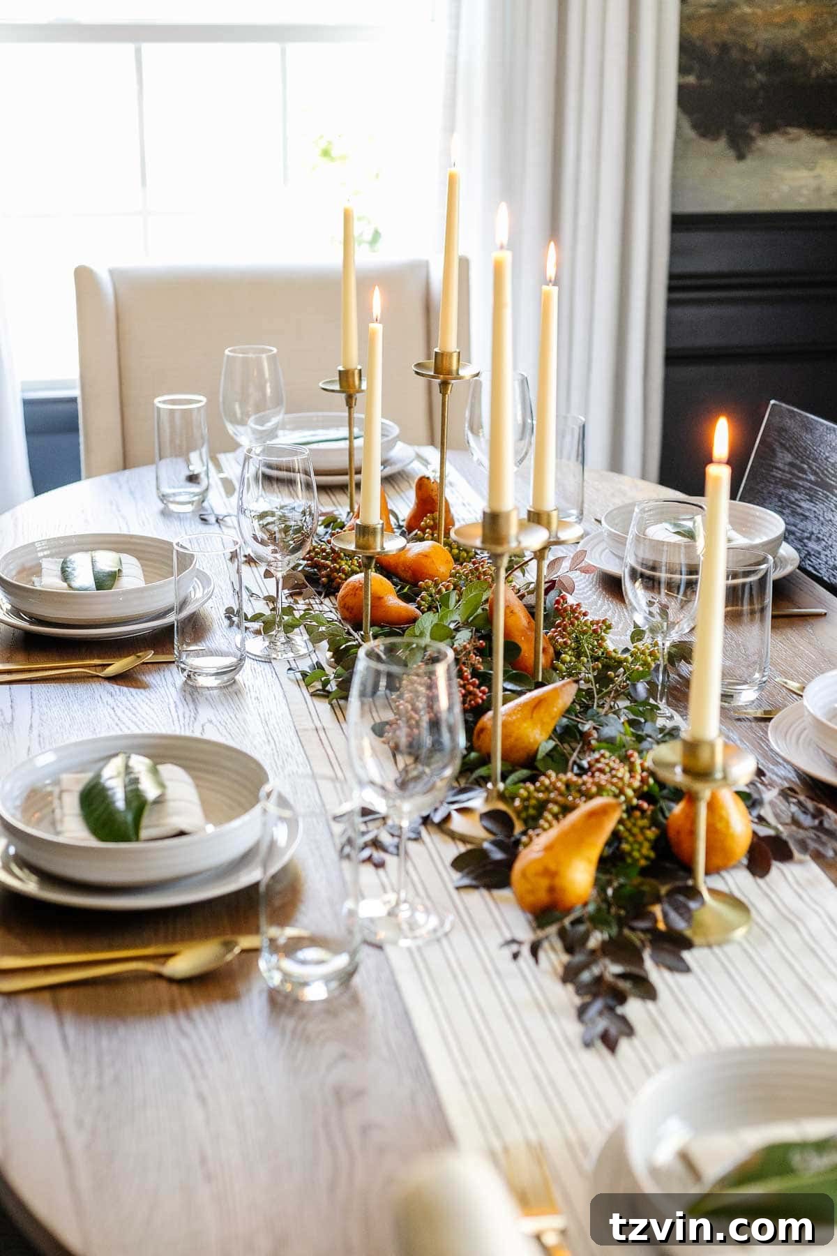 10-Minute Thanksgiving Table Makeover 6 Thanksgiving centerpiece assembly: adding berry clusters amidst candles, leaves, and pears for a final touch.