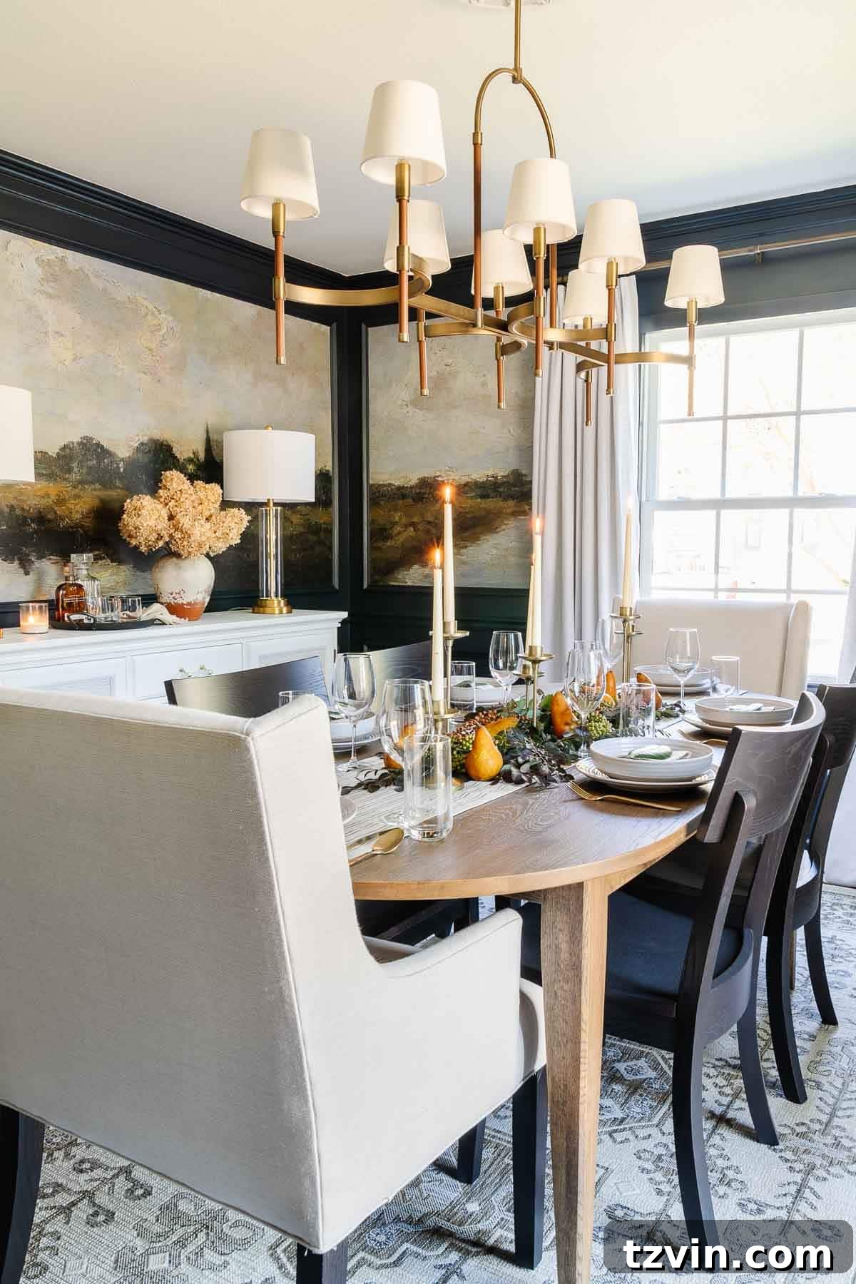 10-Minute Thanksgiving Table Makeover 9 Beautifully decorated Thanksgiving dining room with a long table featuring natural foliage, pears, and candles, set against elegant navy walls.