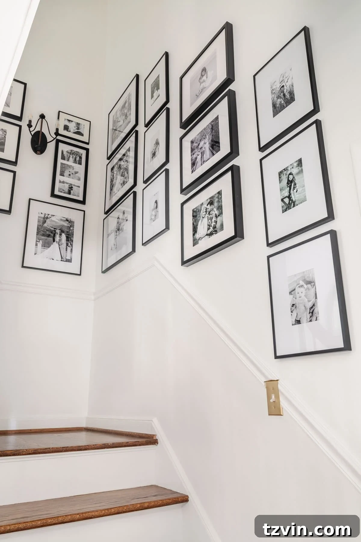 Foyer Fusion Classic Meets Contemporary 14 View of a beautifully arranged black and white staircase gallery wall