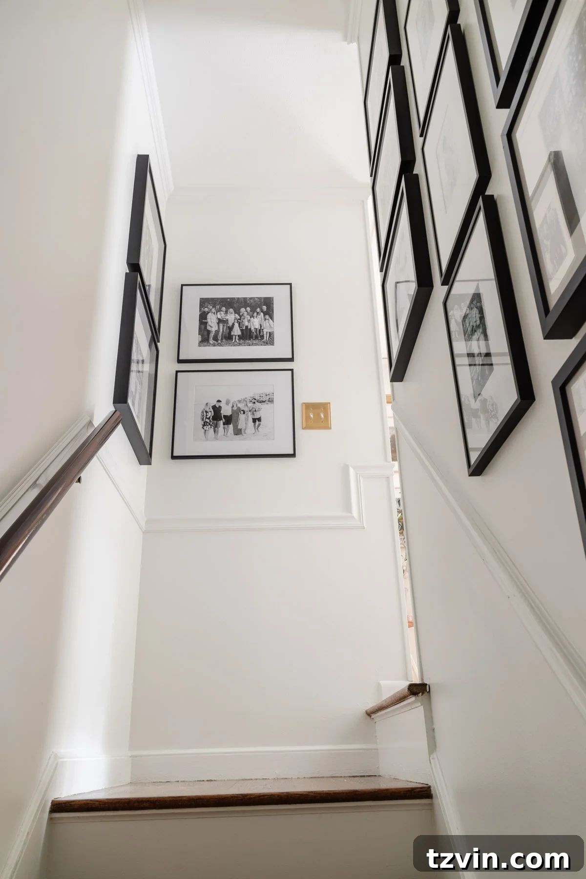 Foyer Fusion Classic Meets Contemporary 16 Overview of a family stairway gallery wall displaying numerous cherished moments
