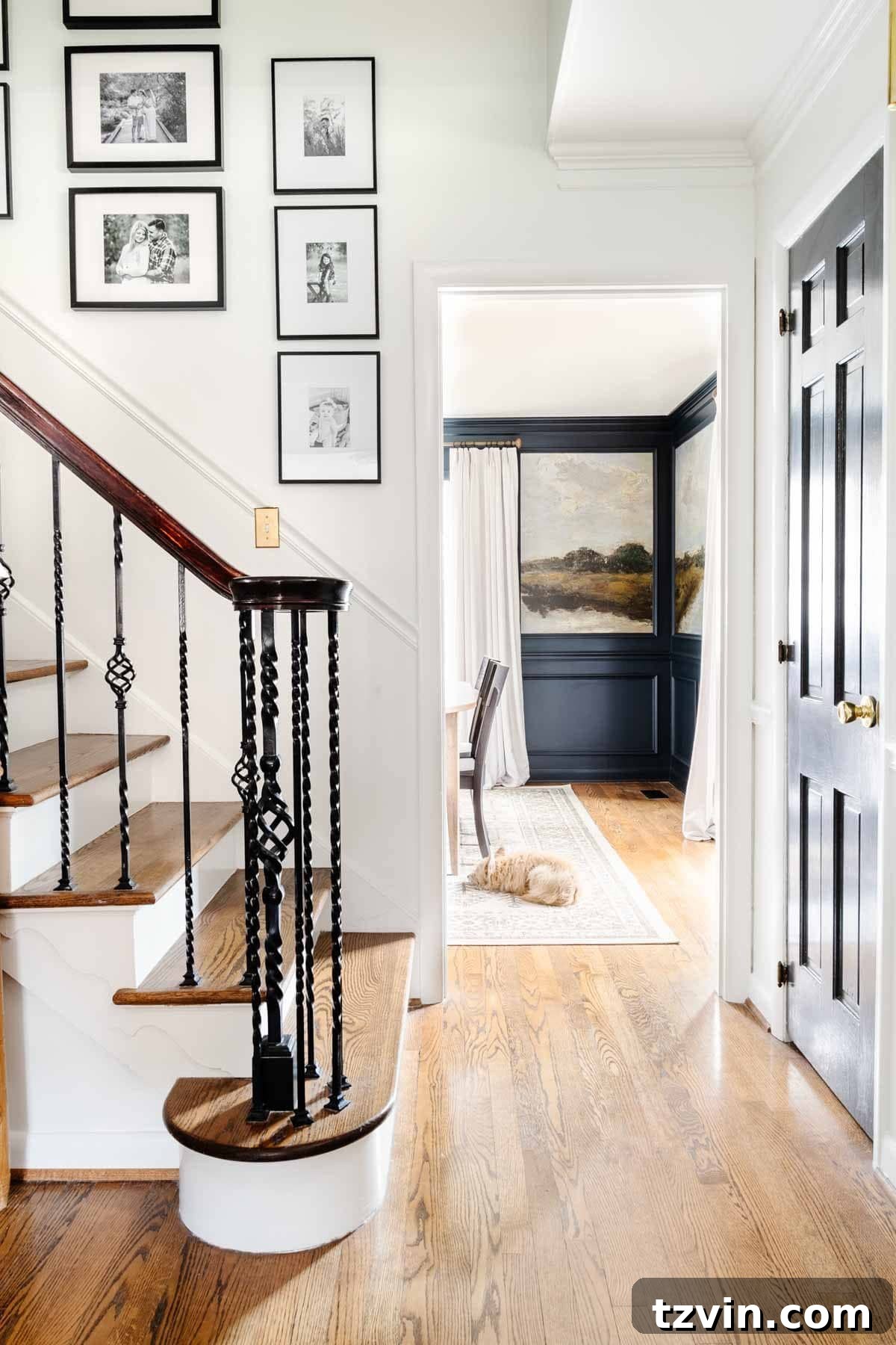 Foyer Fusion Classic Meets Contemporary 7 Stairway gallery wall with family photos, leading into a dining room featuring a captivating mural wallpaper