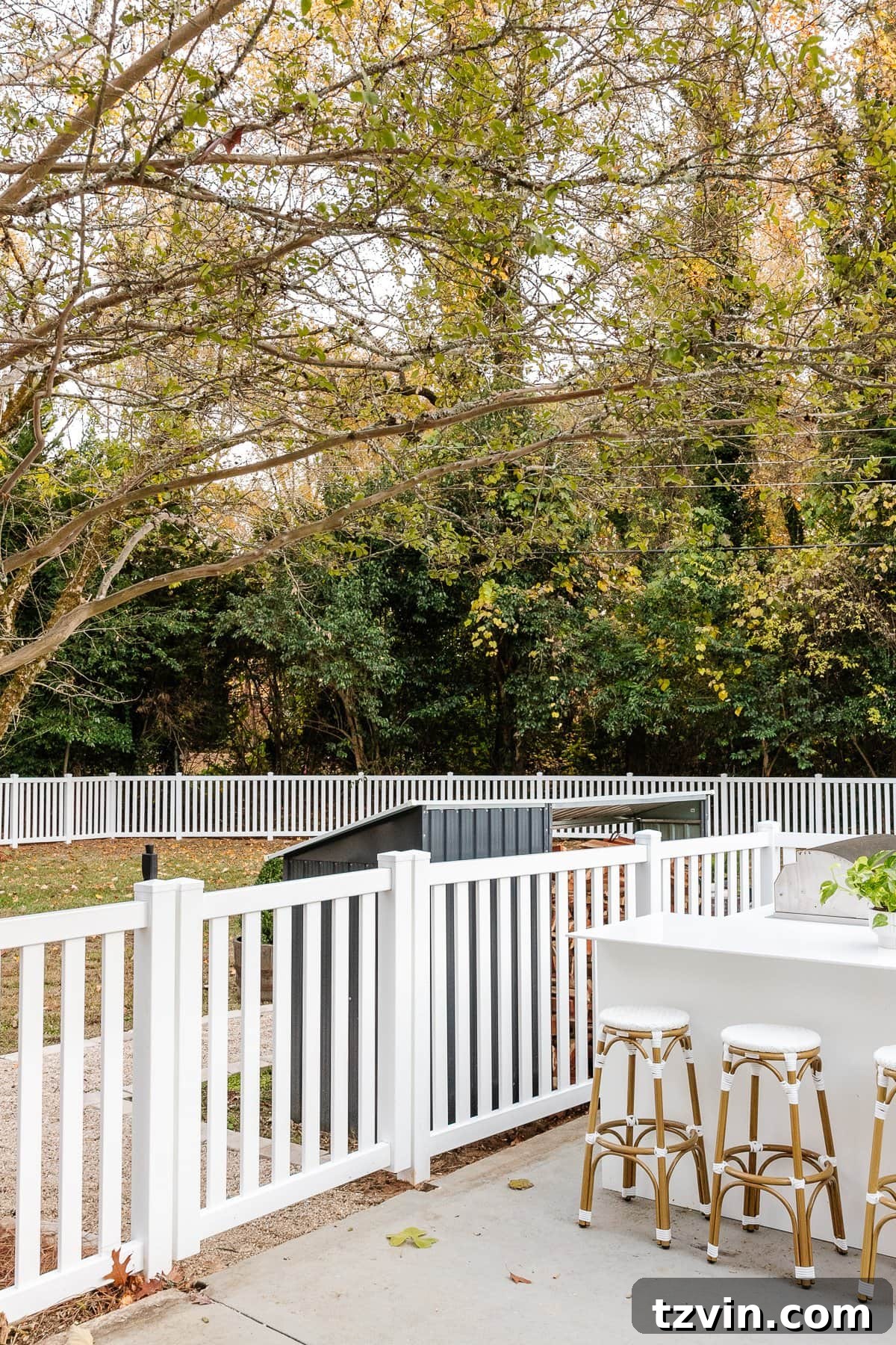 backyard with new white vinyl fence installation 