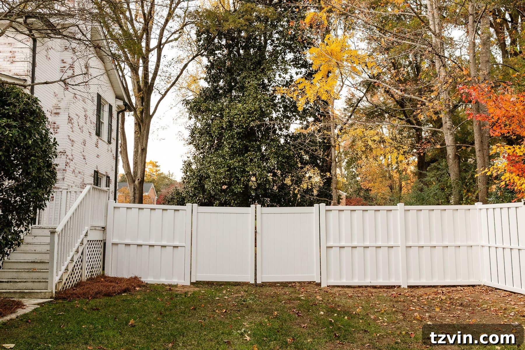 white vinyl fence installation in a backyard using Ply Gem