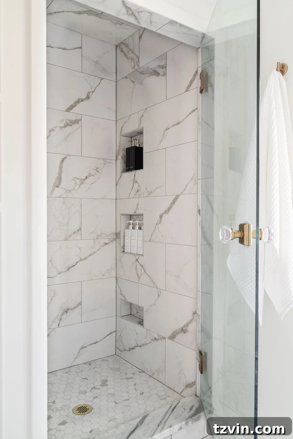 Step Inside Our Modern Vintage En Suite Bathroom Oasis 17 small shower with white marble effect tile and shower niches and glass door with knob