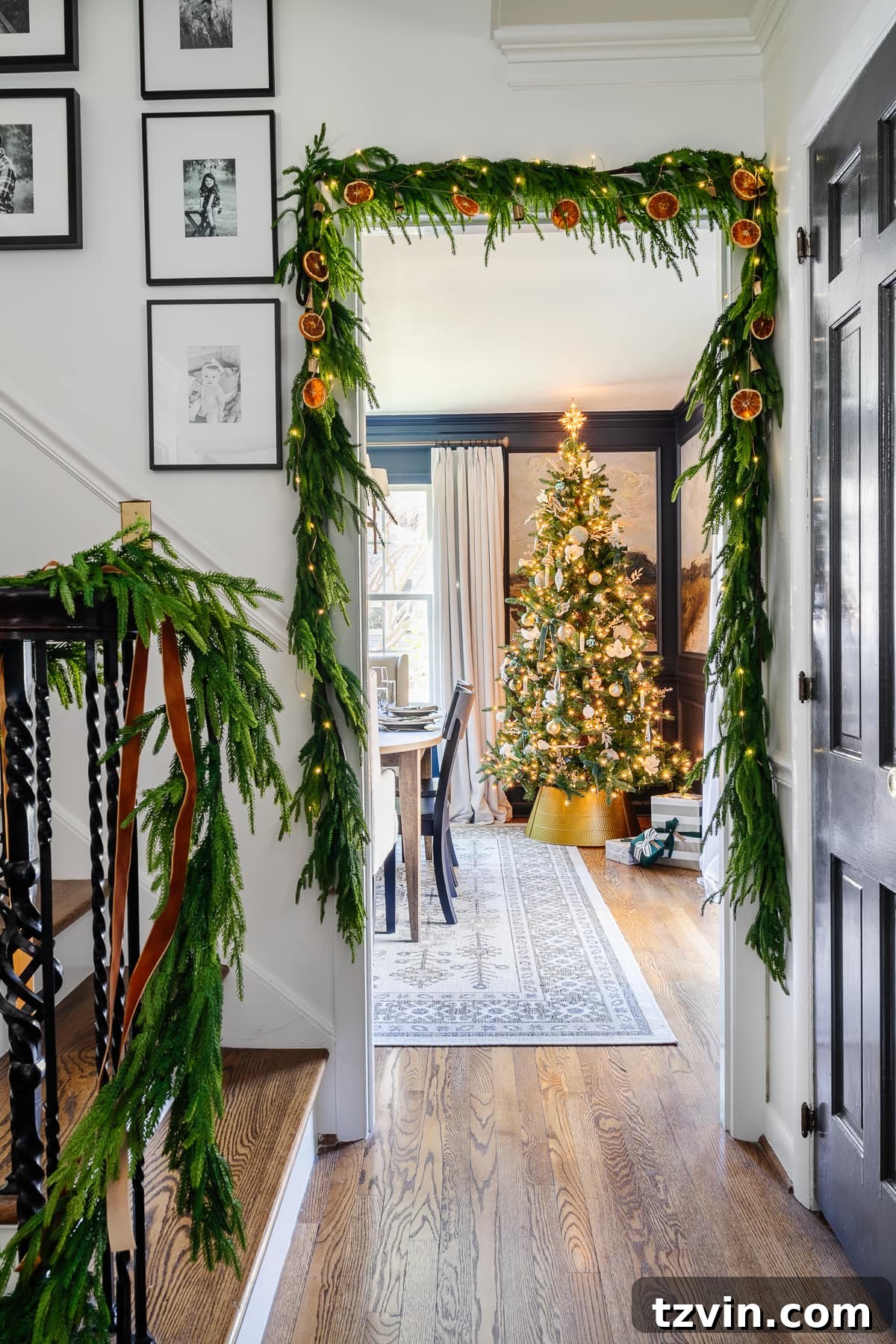 Craft Your Own Beautiful Dried Orange Garland 12 Dried orange garland beautifully draped over greenery around a doorway, serving as elegant Christmas decor.