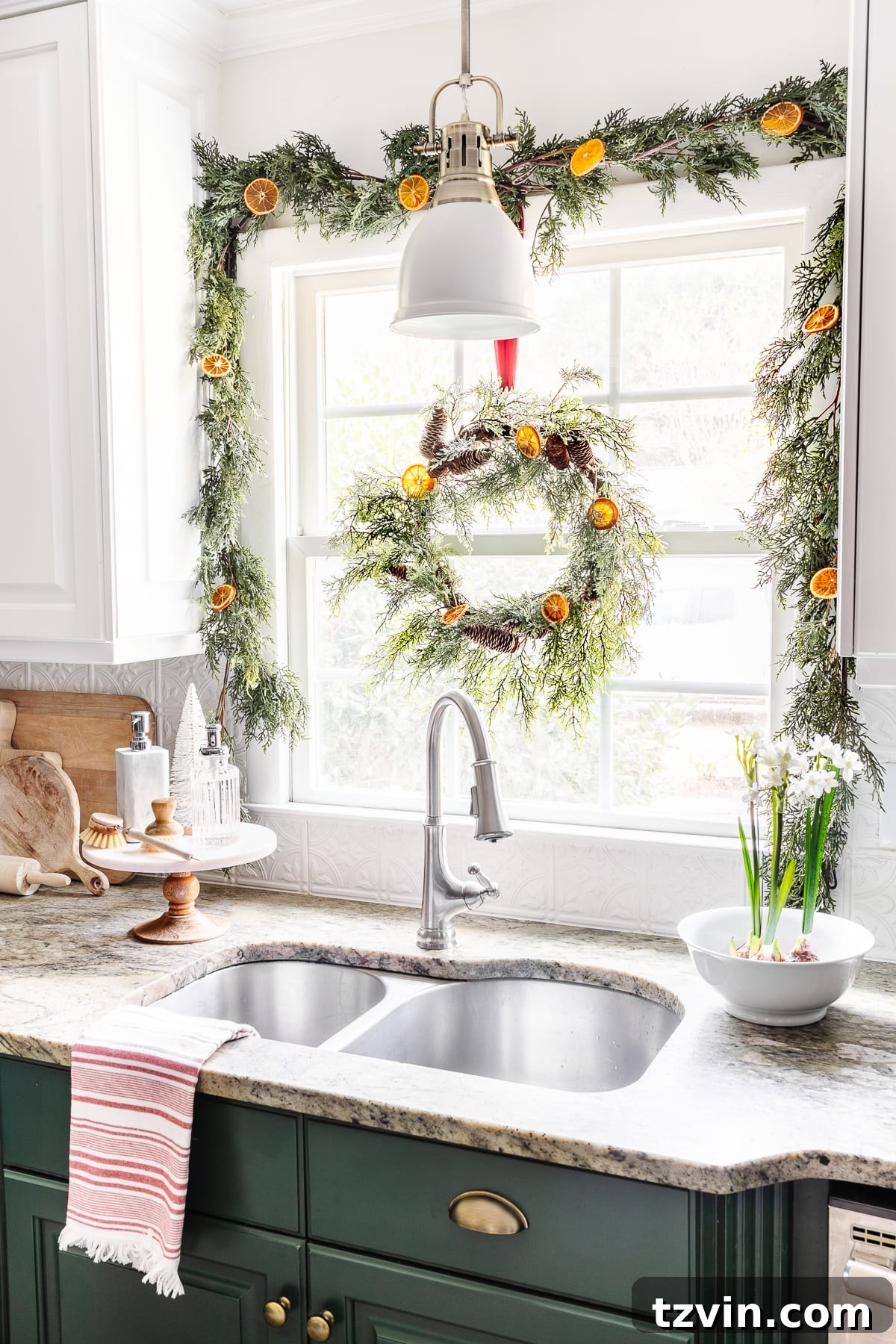 Craft Your Own Beautiful Dried Orange Garland 13 Dried orange slices mixed with garland and a wreath around a kitchen window, creating a warm holiday ambiance.