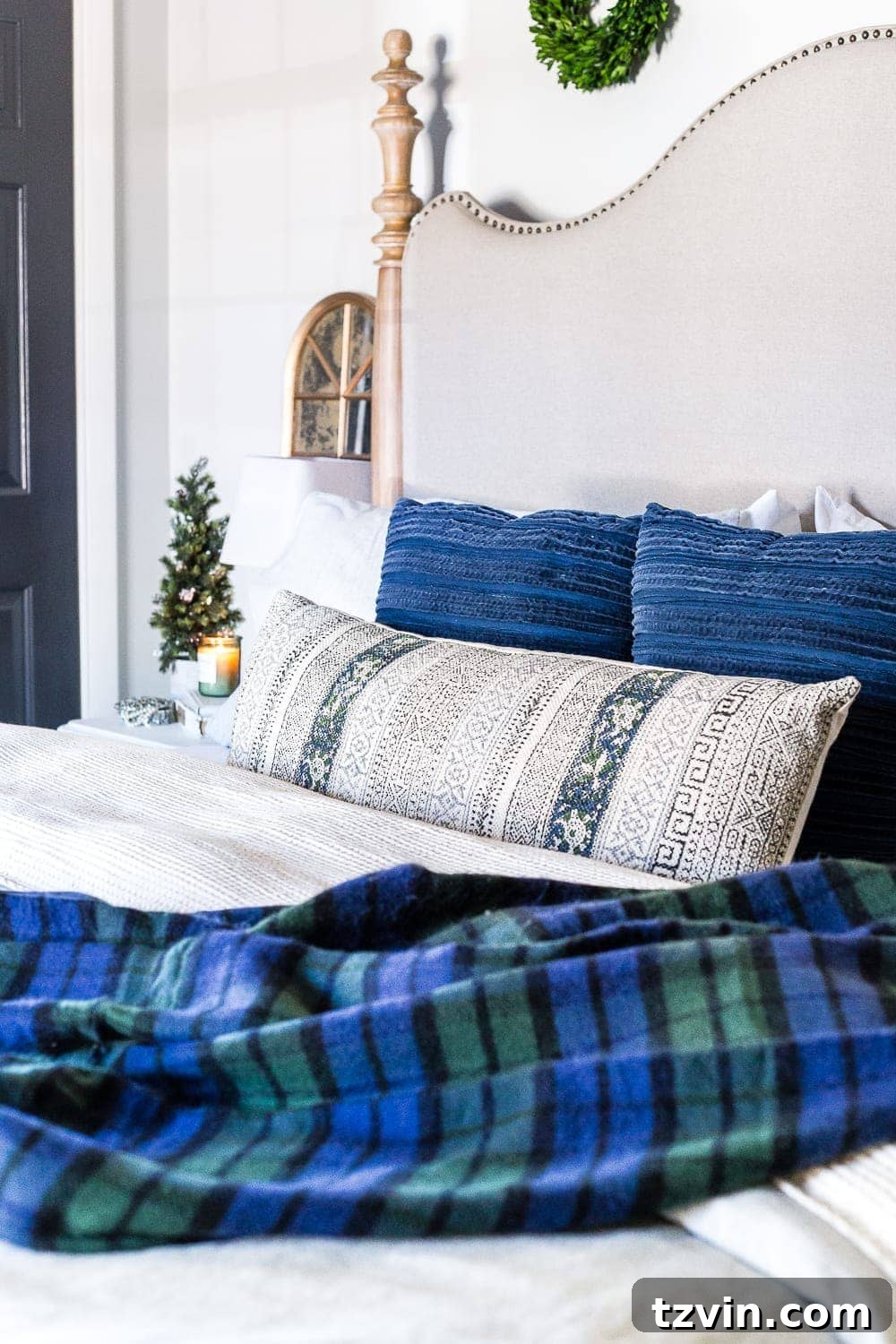 green and blue plaid blanket on a bed