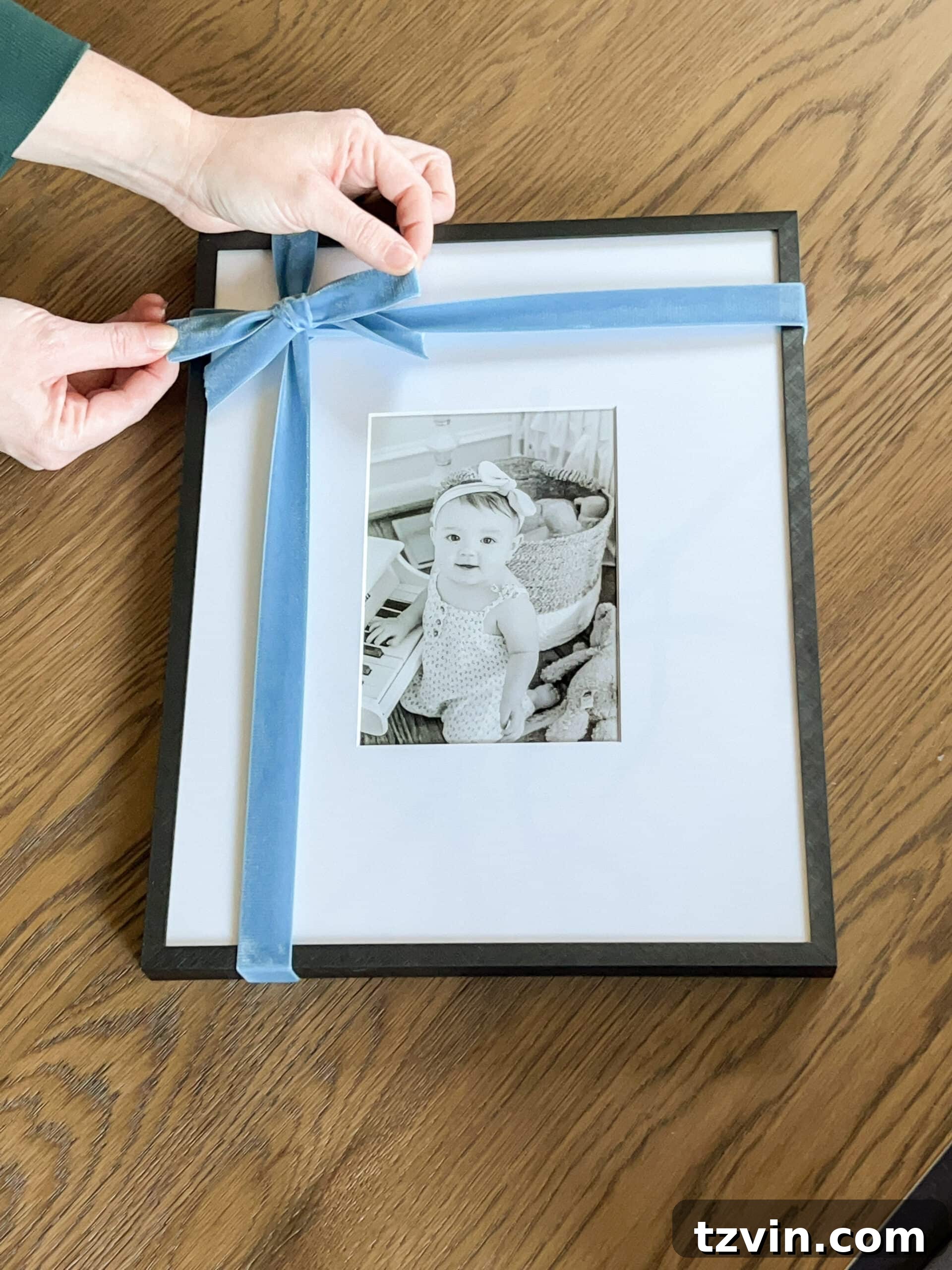 tying a bow around a picture frame